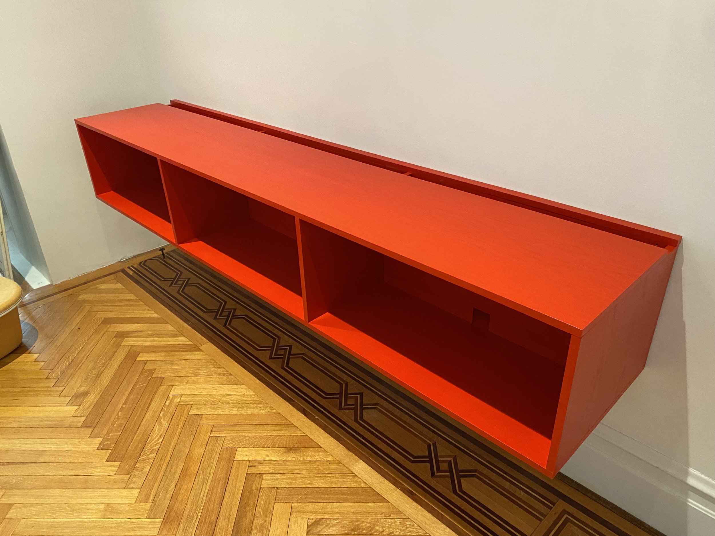 Floating media console in oak with a painted finish
