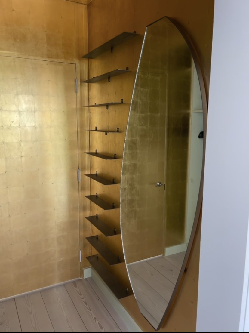 Mirror frame and matching shelving made from stainless in a brushed finish