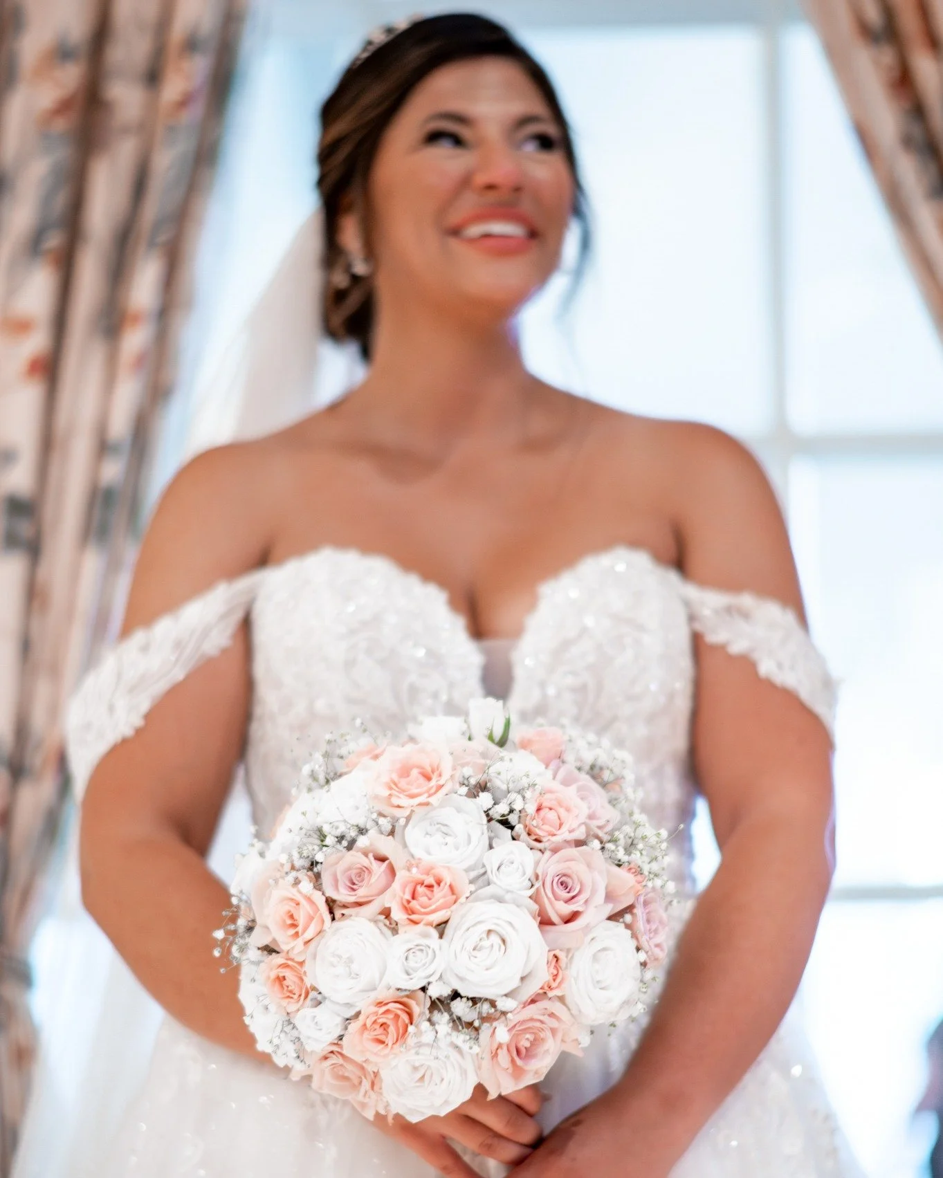 She&rsquo;s not just glowing&hellip; she&rsquo;s radiating happiness ✨🤍

From the sparkle of her gown to those romantic off-the-shoulder sleeves, every detail feels soft, elegant, and completely her.

And that bouquet&hellip; the perfect blend of pi