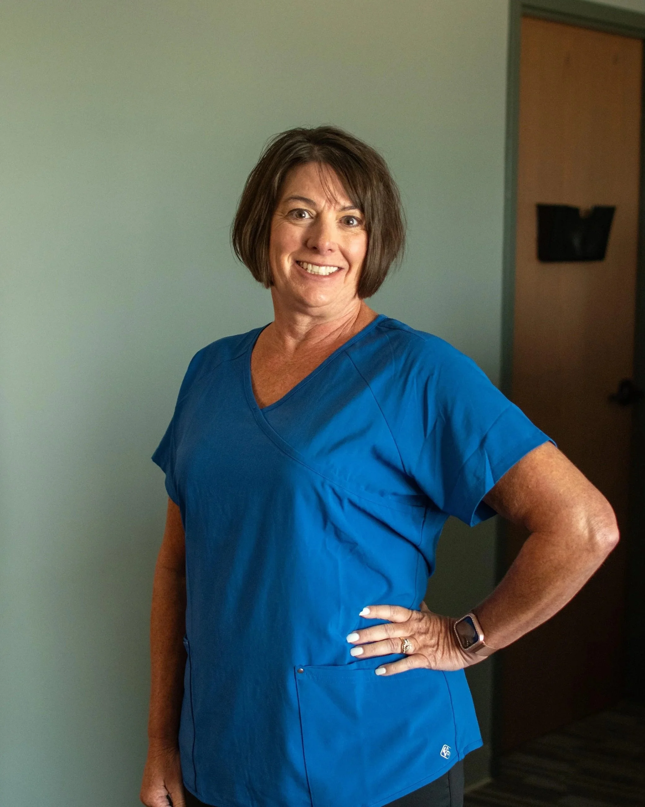 Palm tree leaves against a soft sky background.