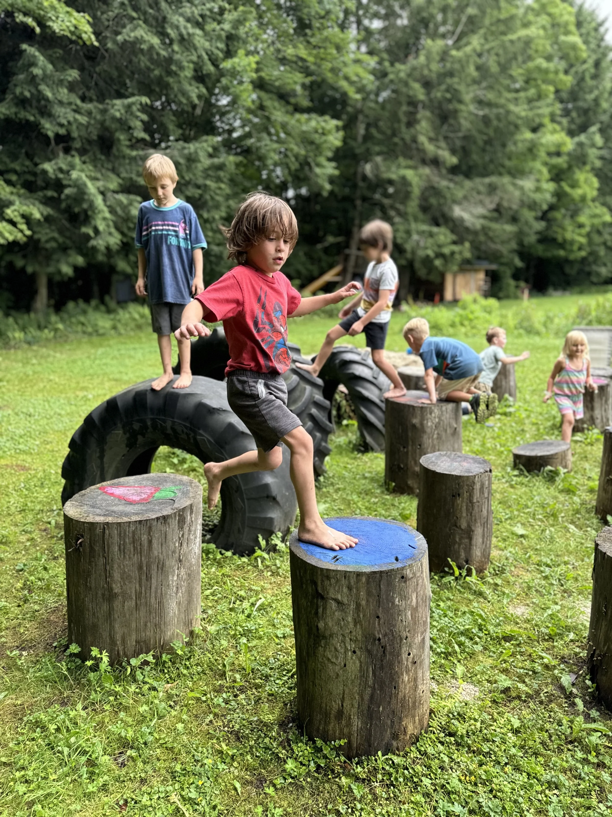 Camp kids log leaping.jpeg