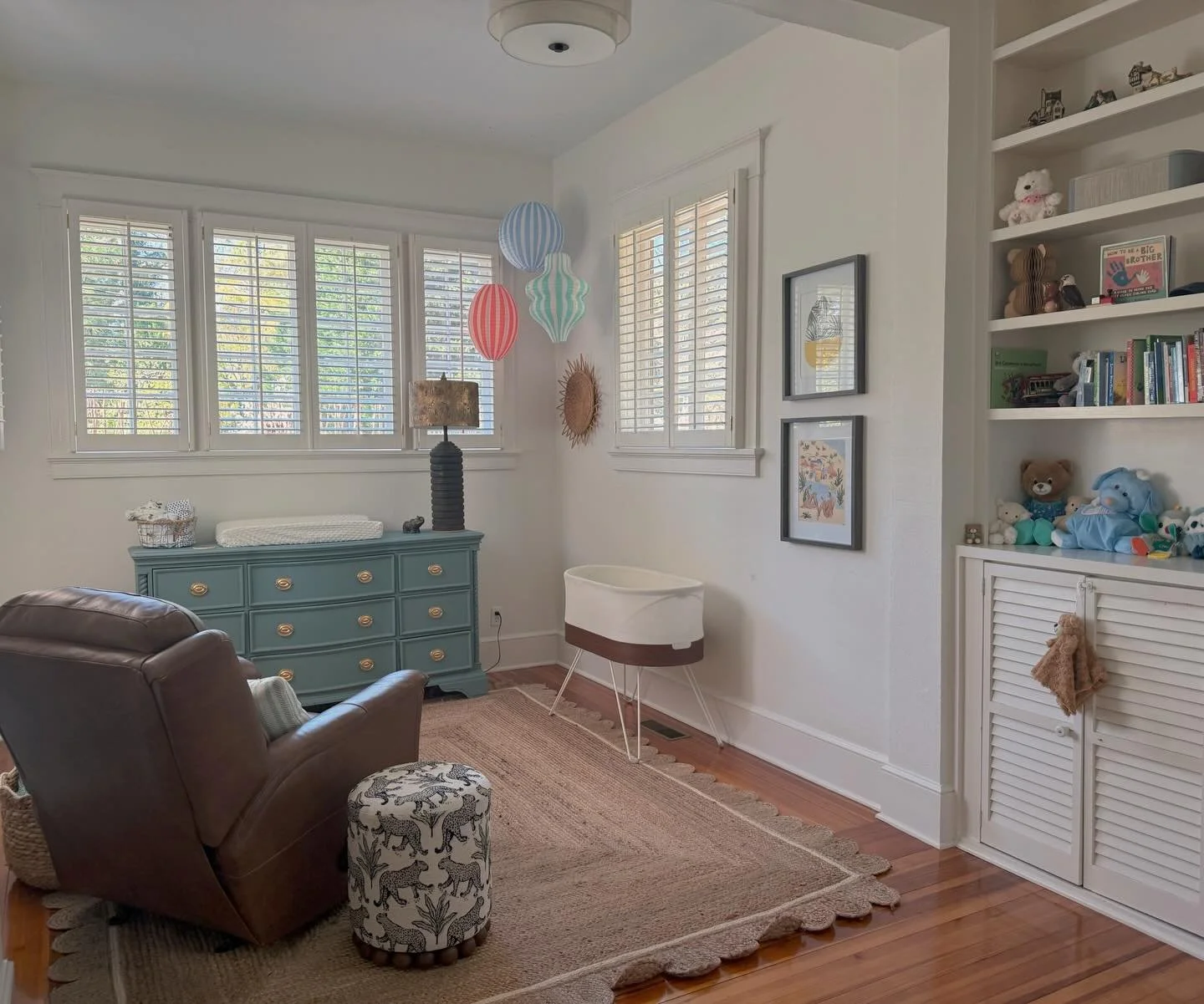 I love a simple and a bright nursery where mom and dad can clock some hours. For this baby boy, we mixed browns and greens with pops of primary colors. When ceilings are high like this, I love adding some playful lanterns or hot air balloons to one o