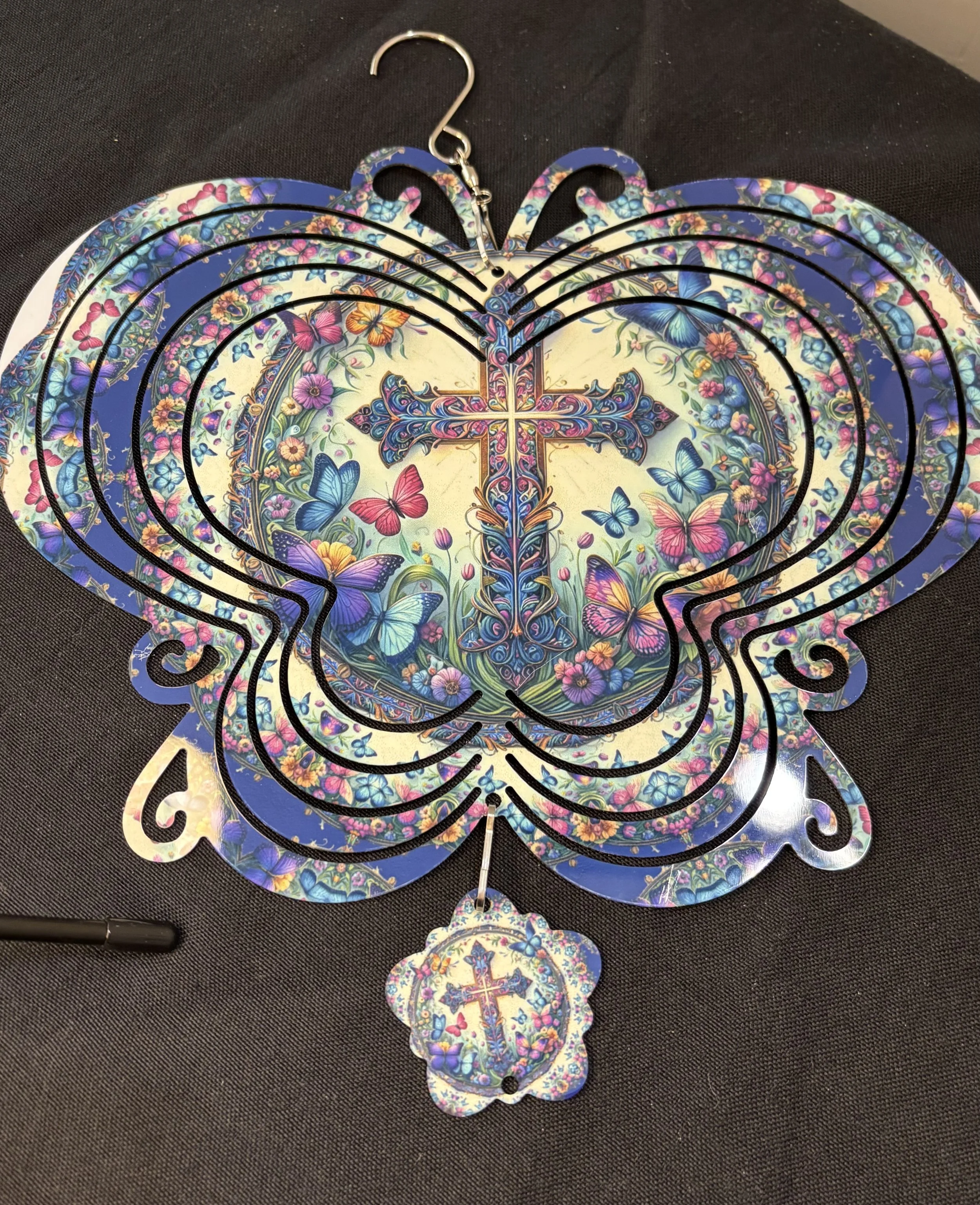 Colorful butterfly-shaped hanging decoration with a cross and butterflies design