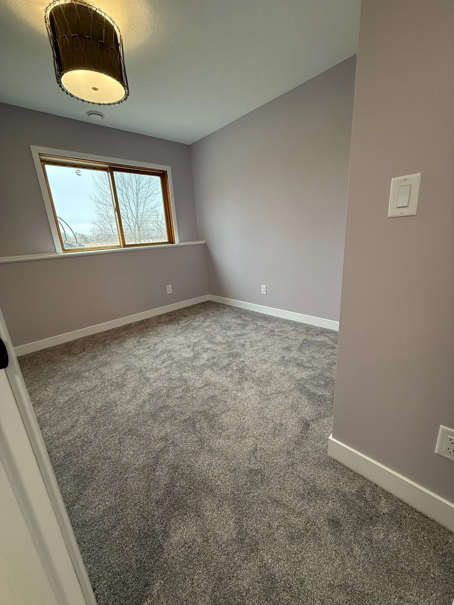Finished bedroom, modern style trim, and light fixtures.