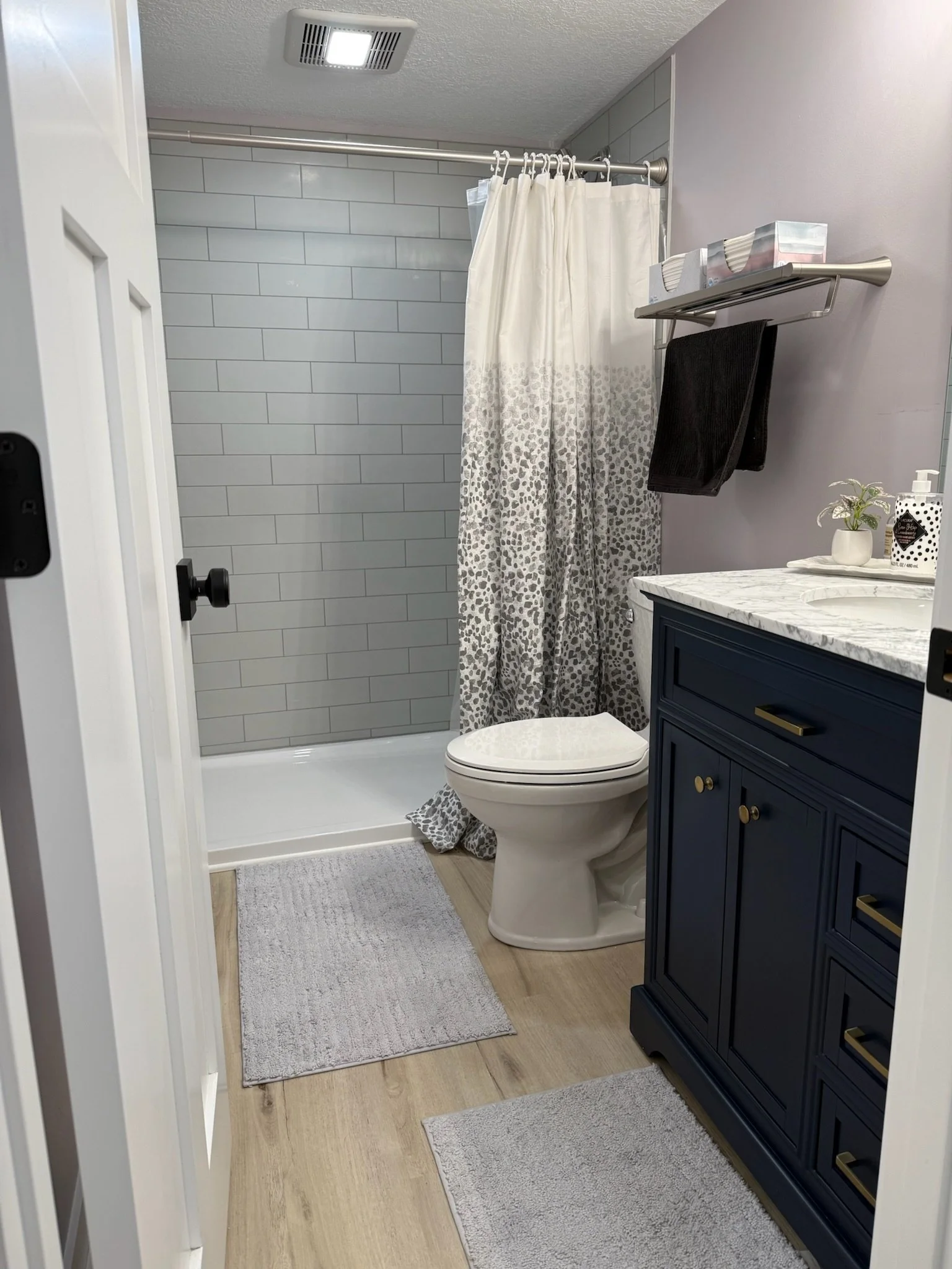 Modern and clean bathroom post remodel with new vanity and redone shower