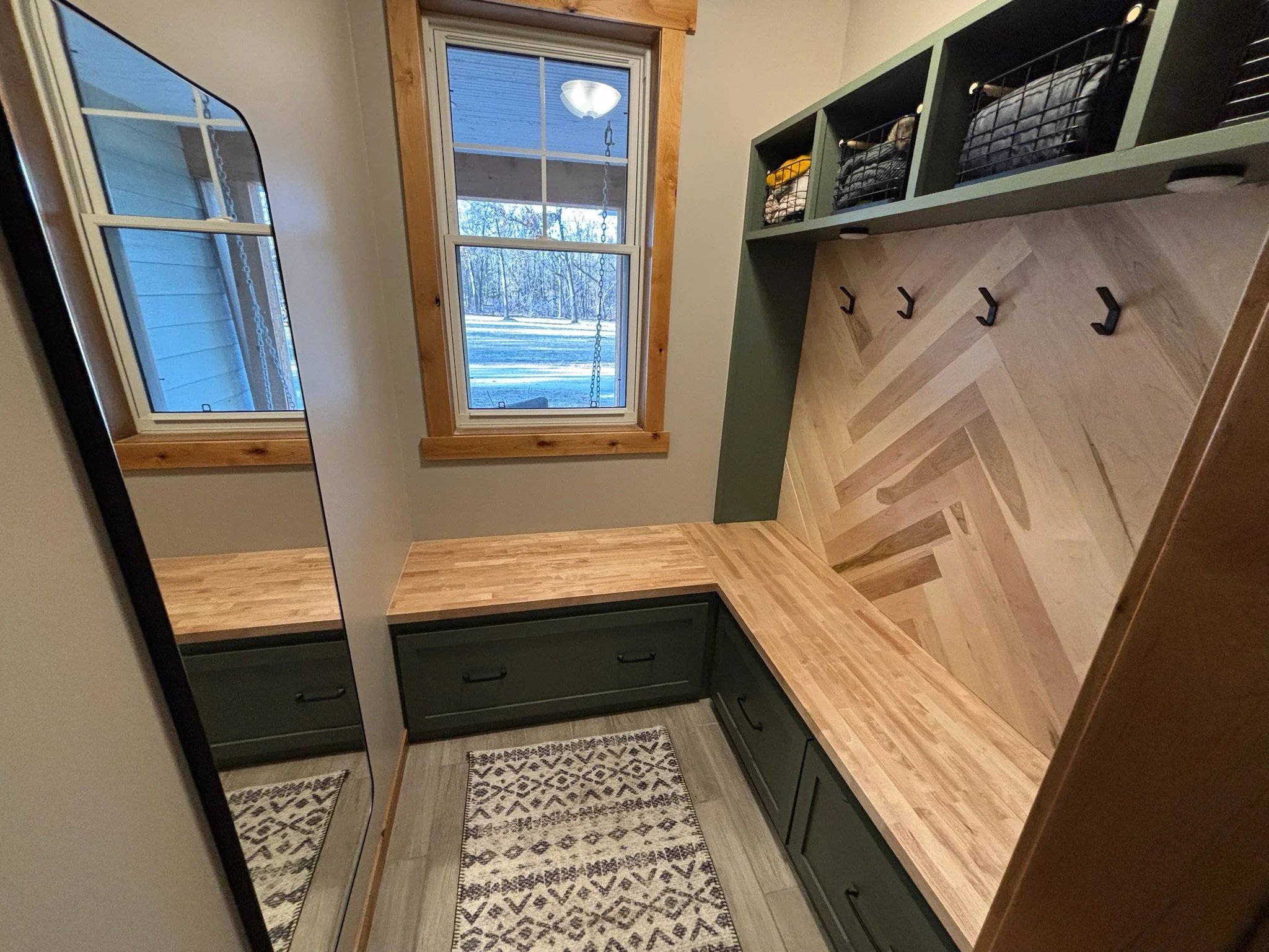 Custom shoe storage drawers in remodeled Minnesota mudroom with floating cubbies