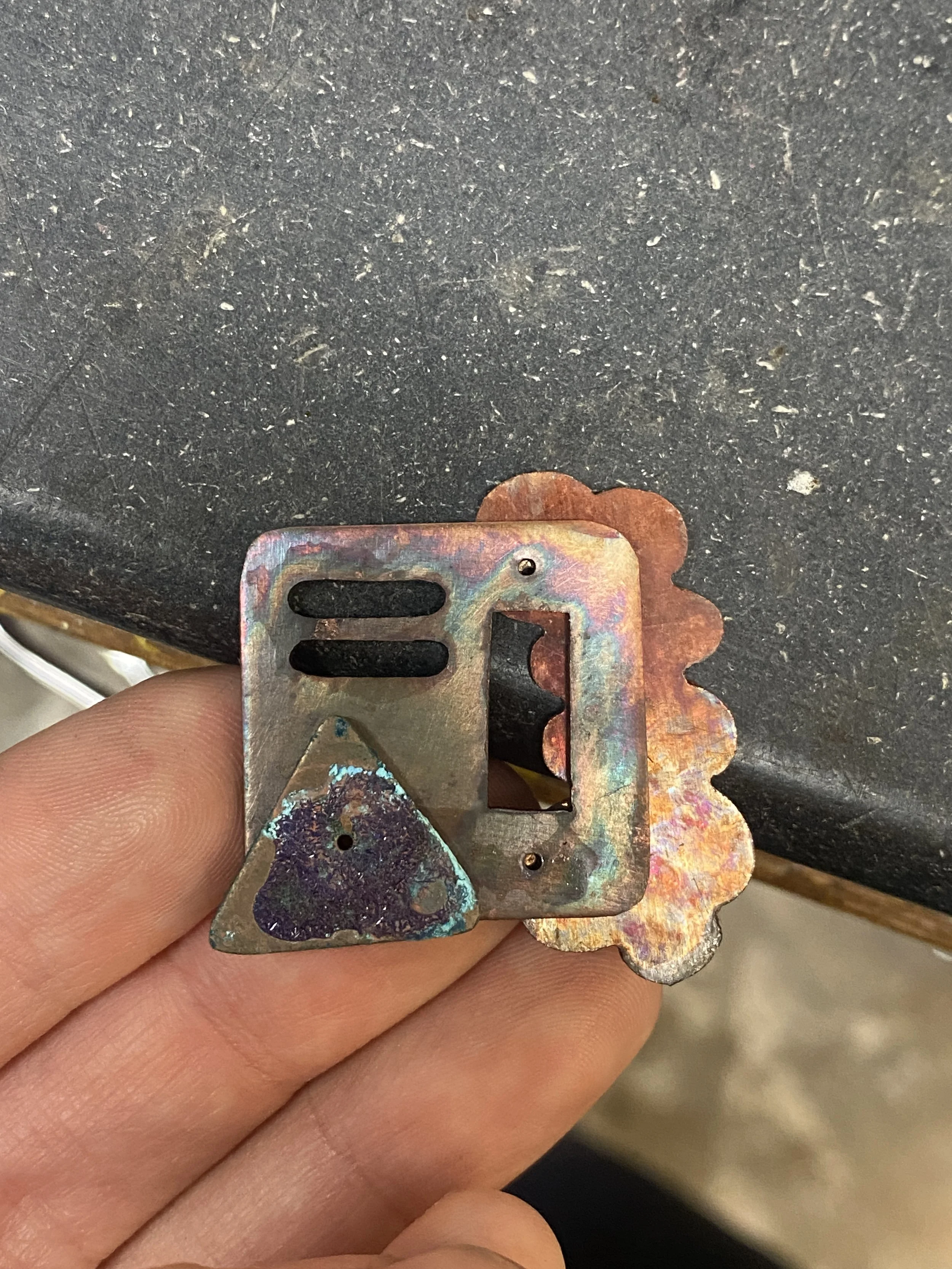 "257258260" brooch after applying sample techniques to each component but before riveting. 