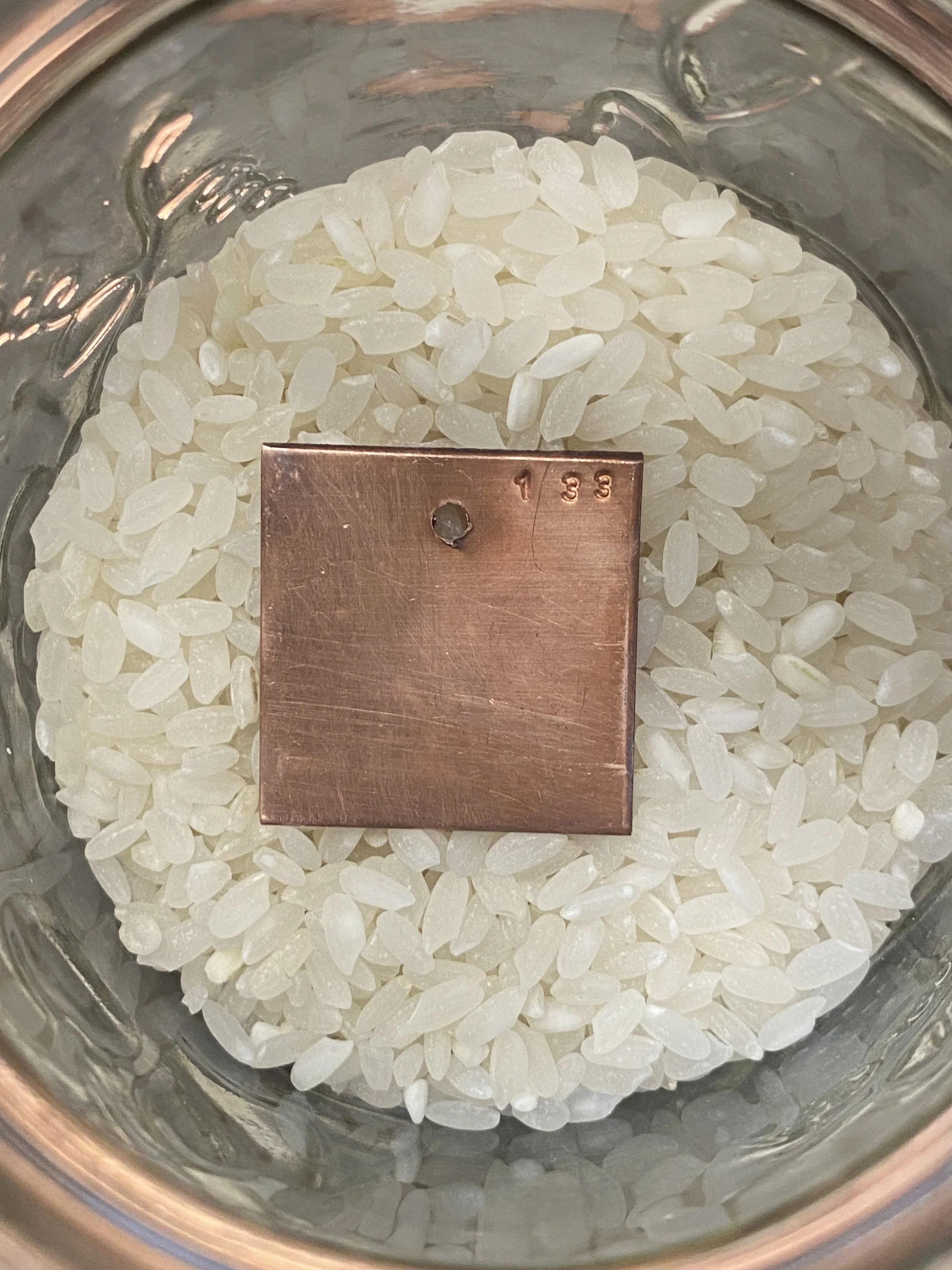 Detail shot of sample in half-filled jar of rice