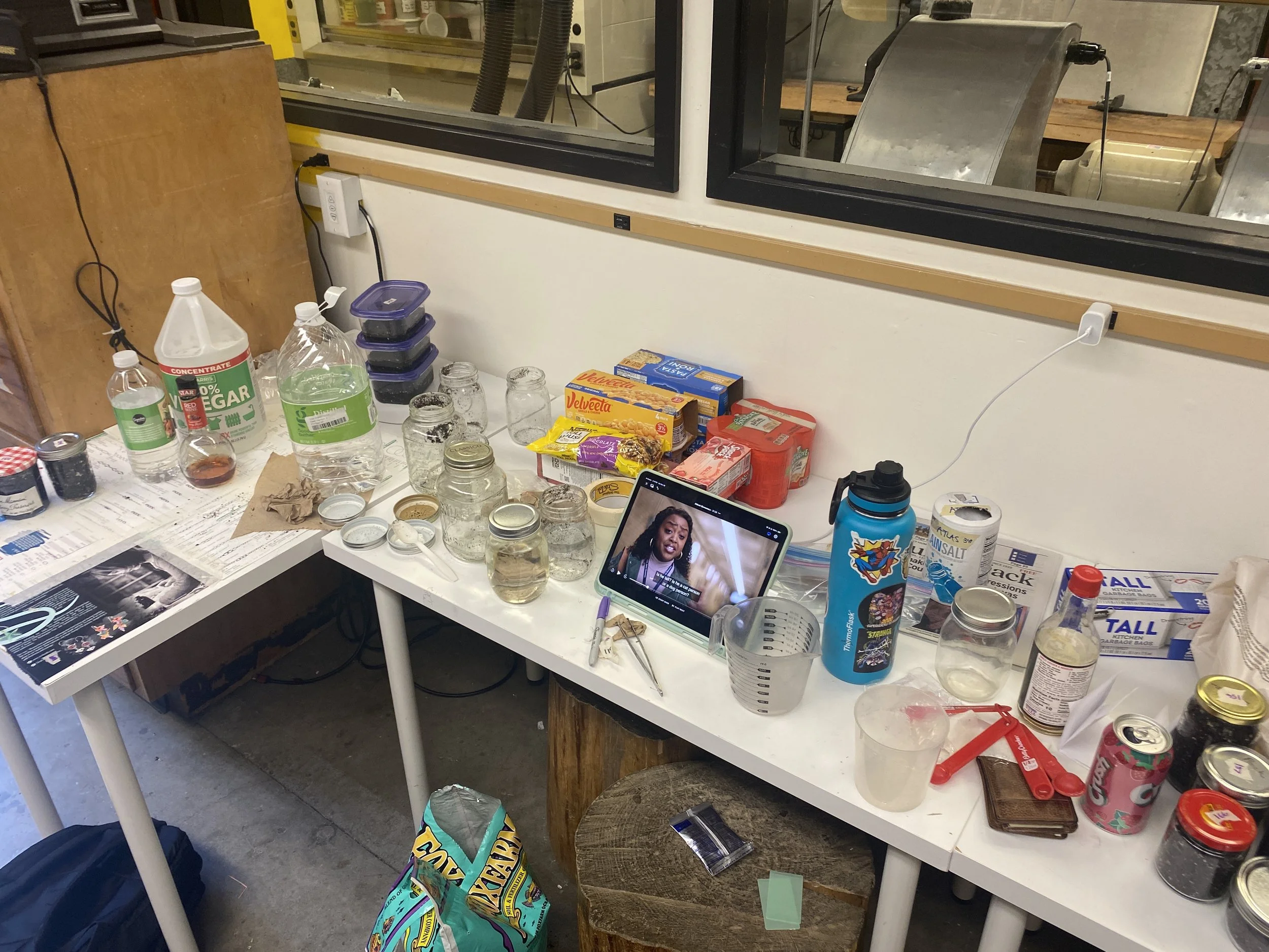 Soil set up for burying (featuring Abbott Elementary in order to not go insane because of the time-intensive process of filling jars with soil, metal, and an assortment of different liquids). 