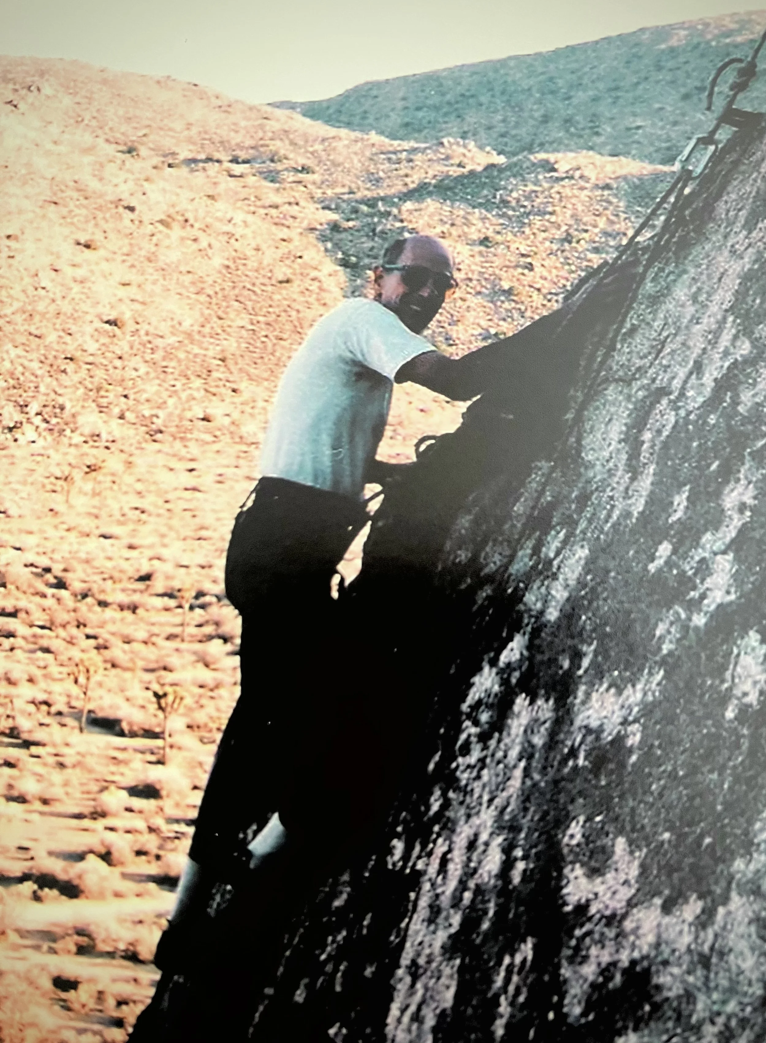 Robert Alt's father, "Dr. Bob," is shown climbing a steep rock face during one of his frequent outdoor adventures.