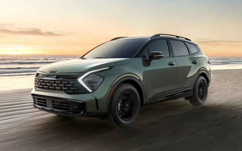 SUV driving on a beach at sunset