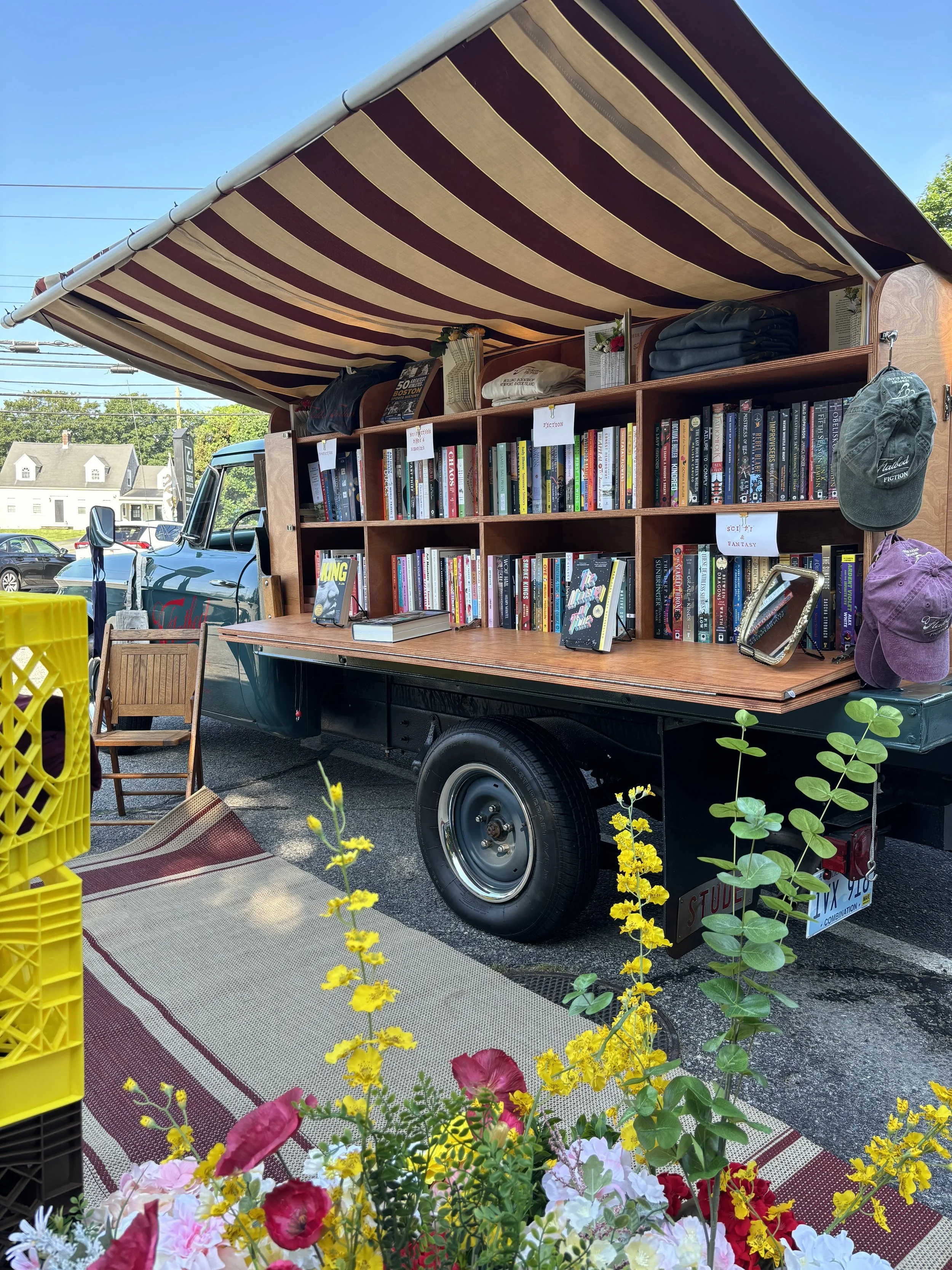 Truck with canvas shade and bookshelves.