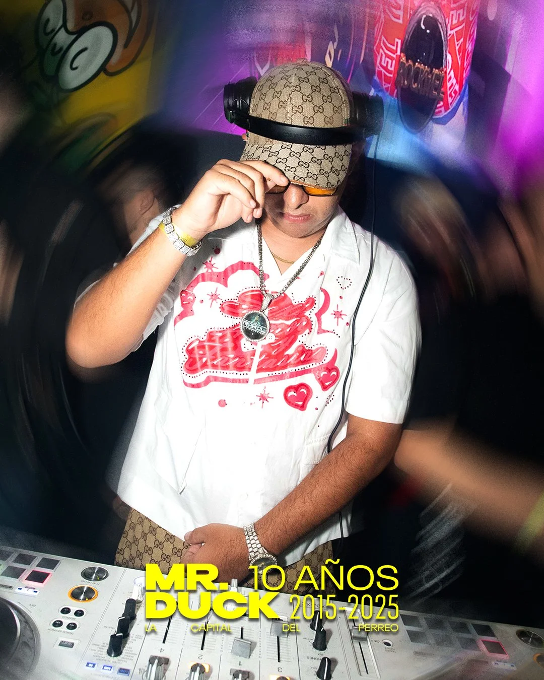 DJ wearing Gucci cap and glasses, with headphones, operating mixing console in a colorful nightclub or party setting.