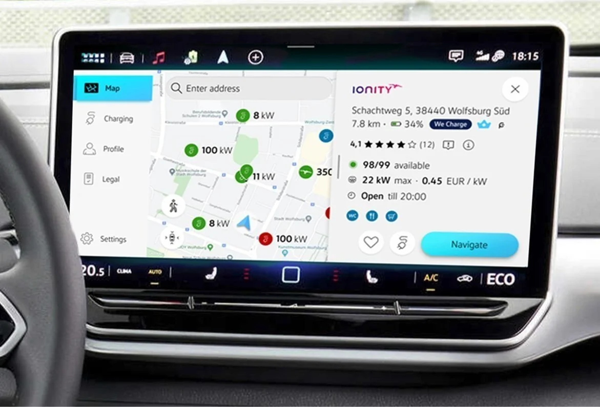 Car infotainment screen displaying a map with electric vehicle charging stations and details about a specific charging station.
