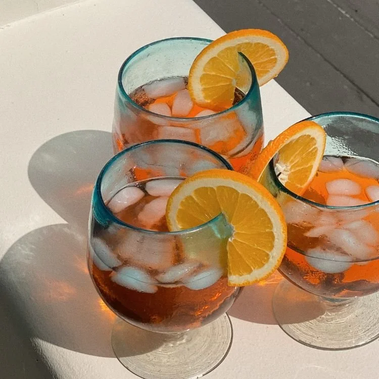 Three drinks with orange slices