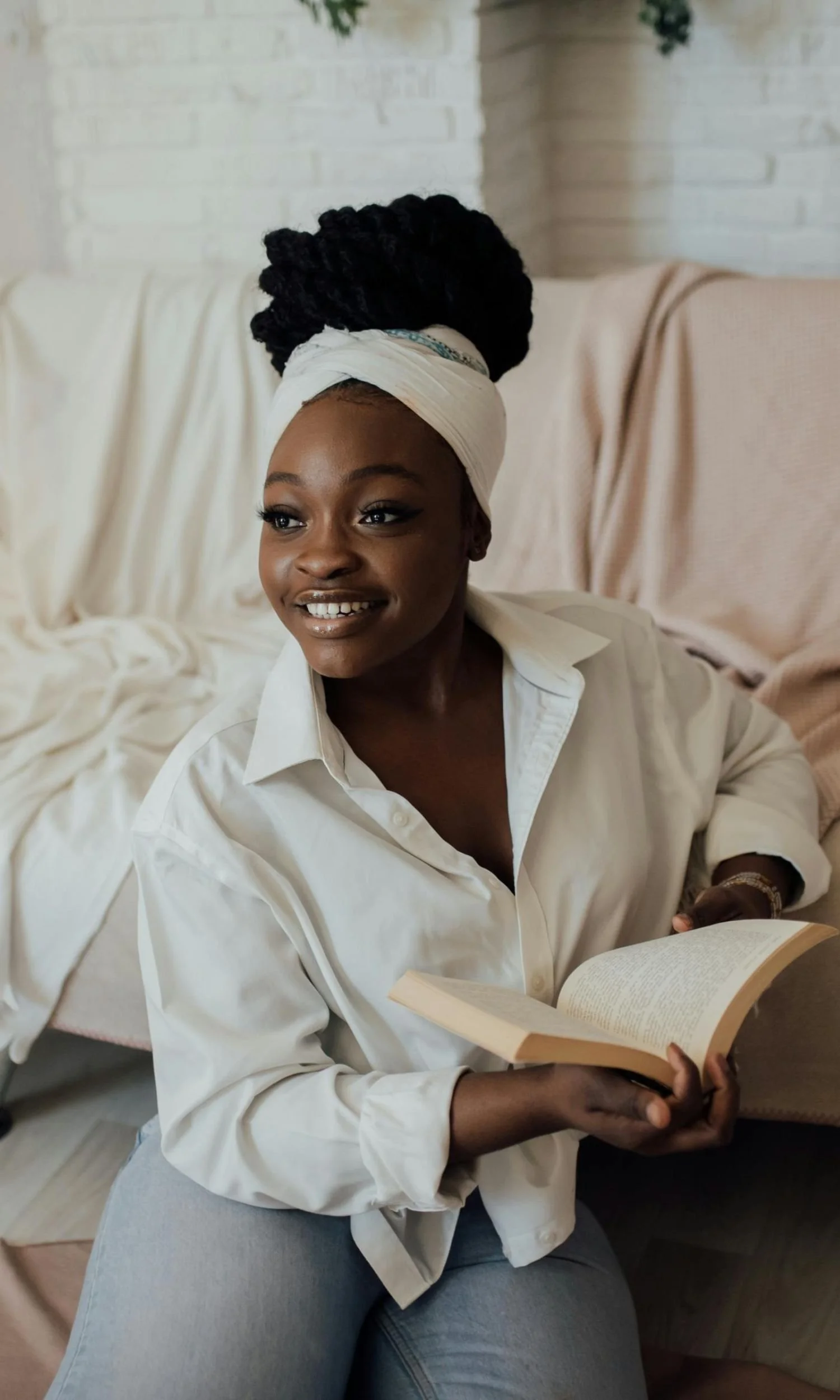 Black woman holding a book and smiling