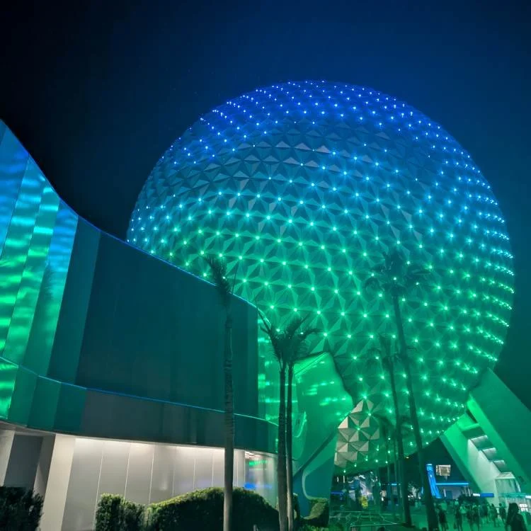 Epcot ball lighting up at night