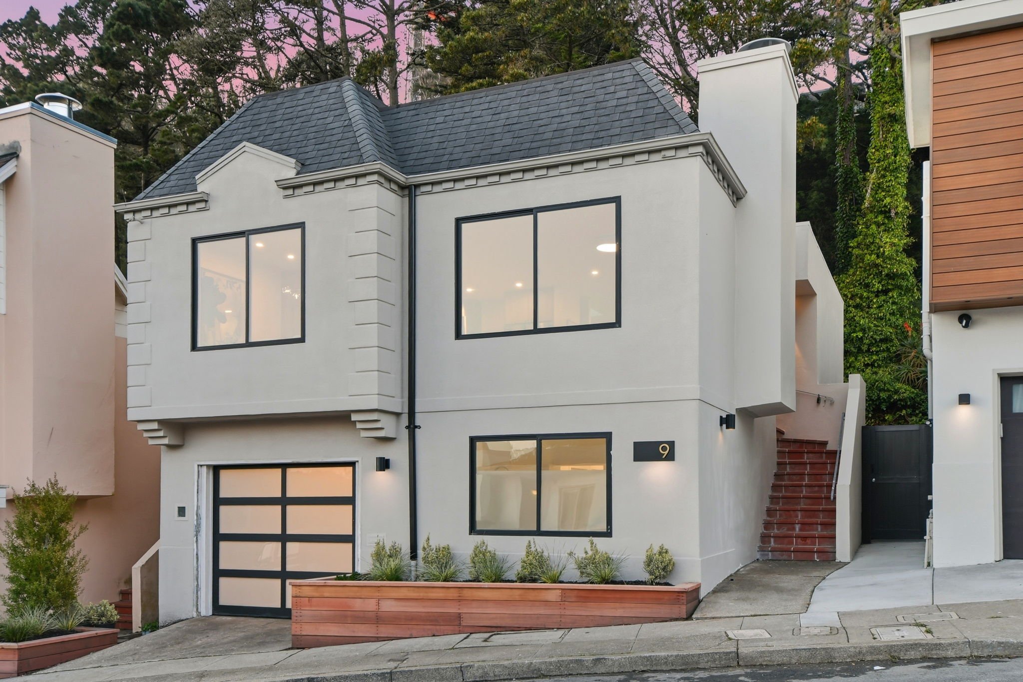 Twilight view of a renovated single-family residence in Midtown Terrace, highlighting its clean modernist lines and hillside San Francisco location.