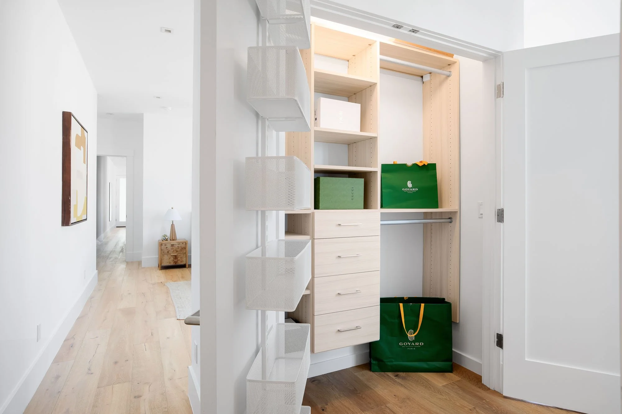 Custom walk-in closet with built-in organizers, drawers, and shelving in a high-end Mission District residential building.