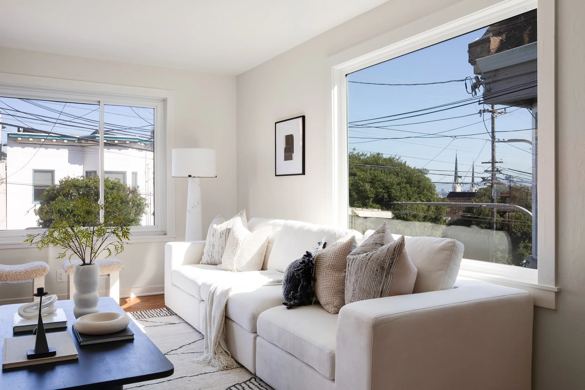 Living room corner at 465 30th Street with new windows on two walls, framing the spires of St. Paul’s Church and the downtown San Francisco skyline