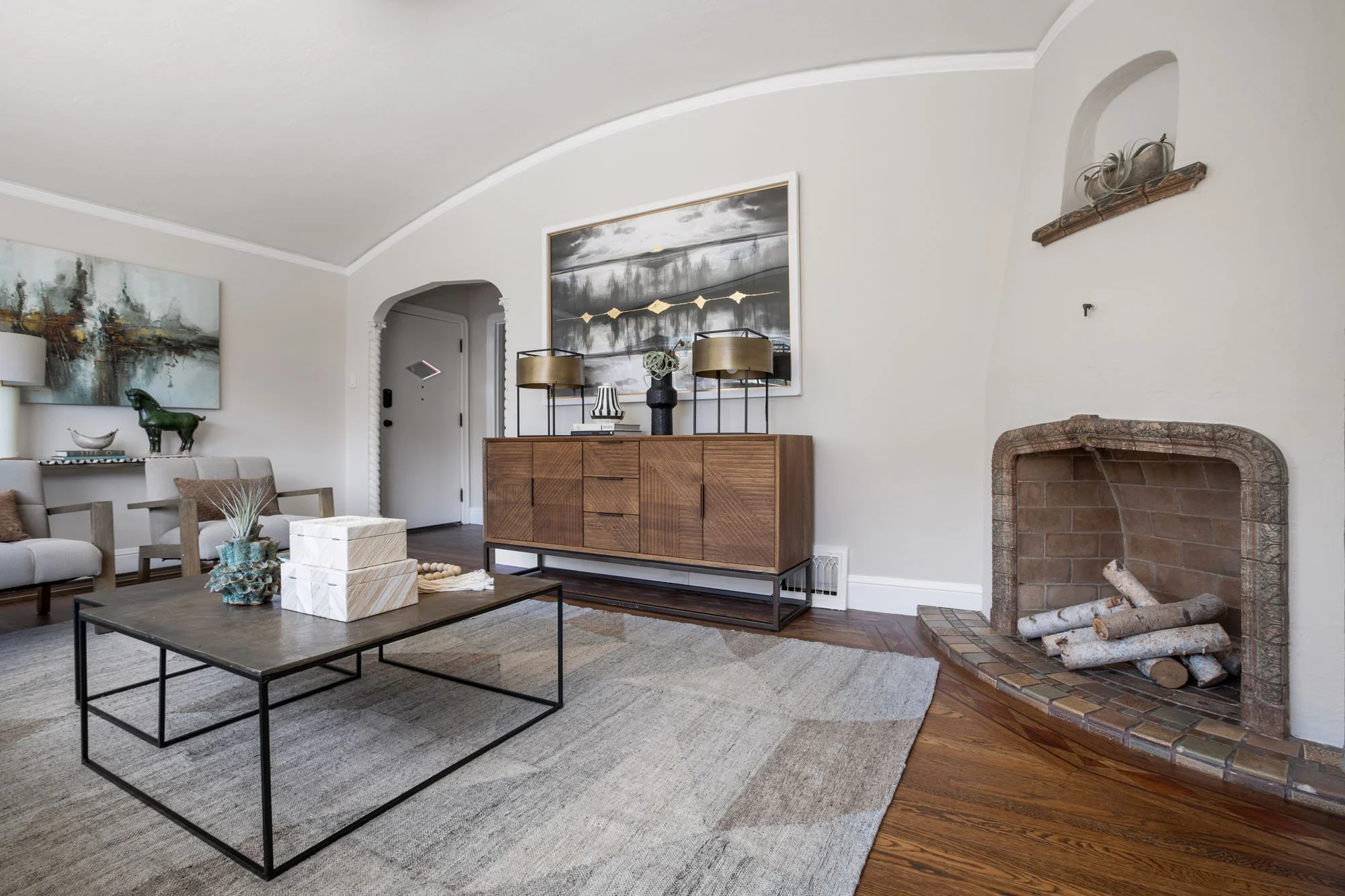 Architectural detail of a period-style fireplace and coved ceilings in a masterfully staged Mission District home.