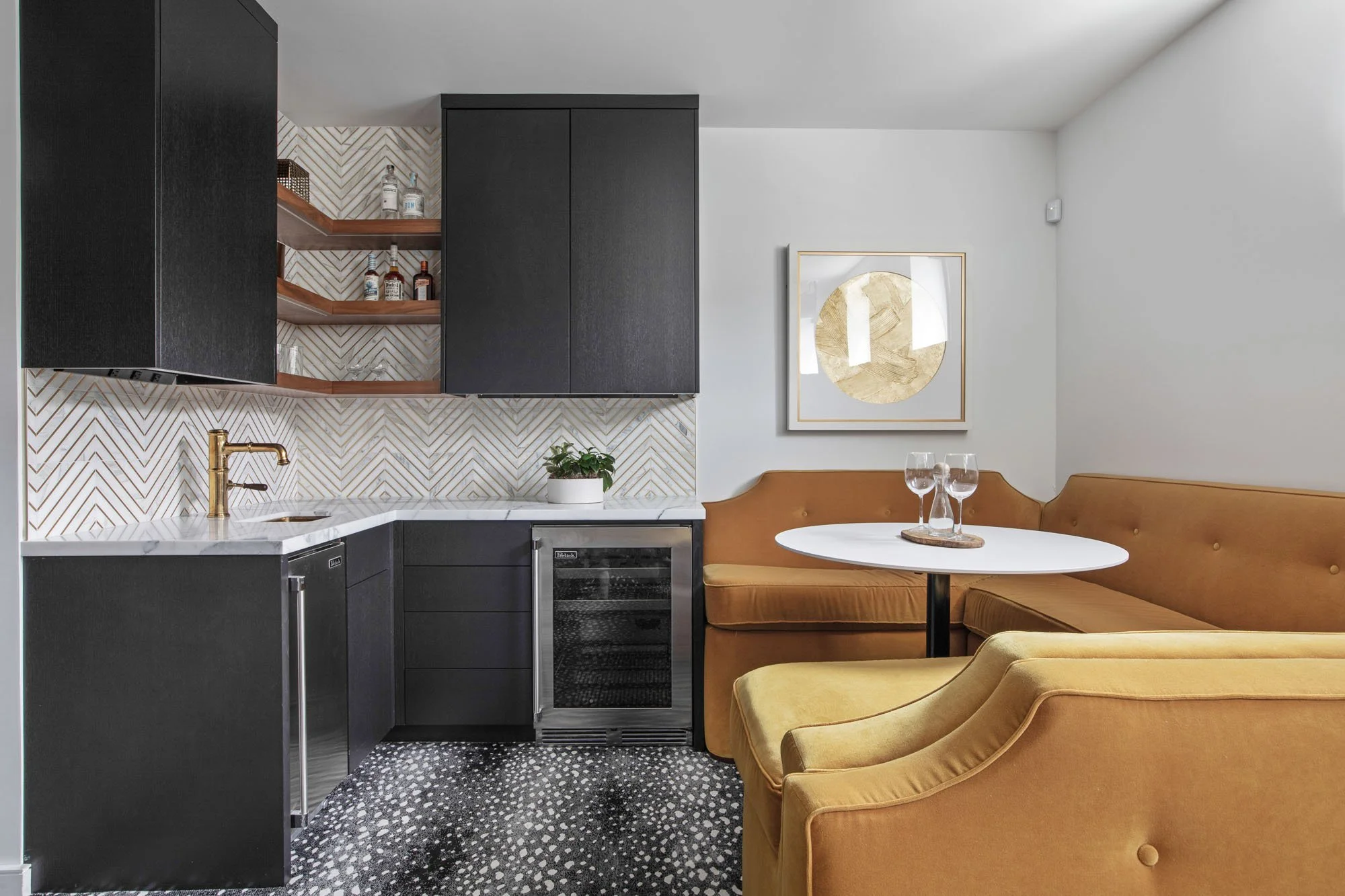 Modern home bar and lounge at 1647 Sanchez with a chevron marble backsplash, dark cabinetry, and ochre velvet banquette seating.