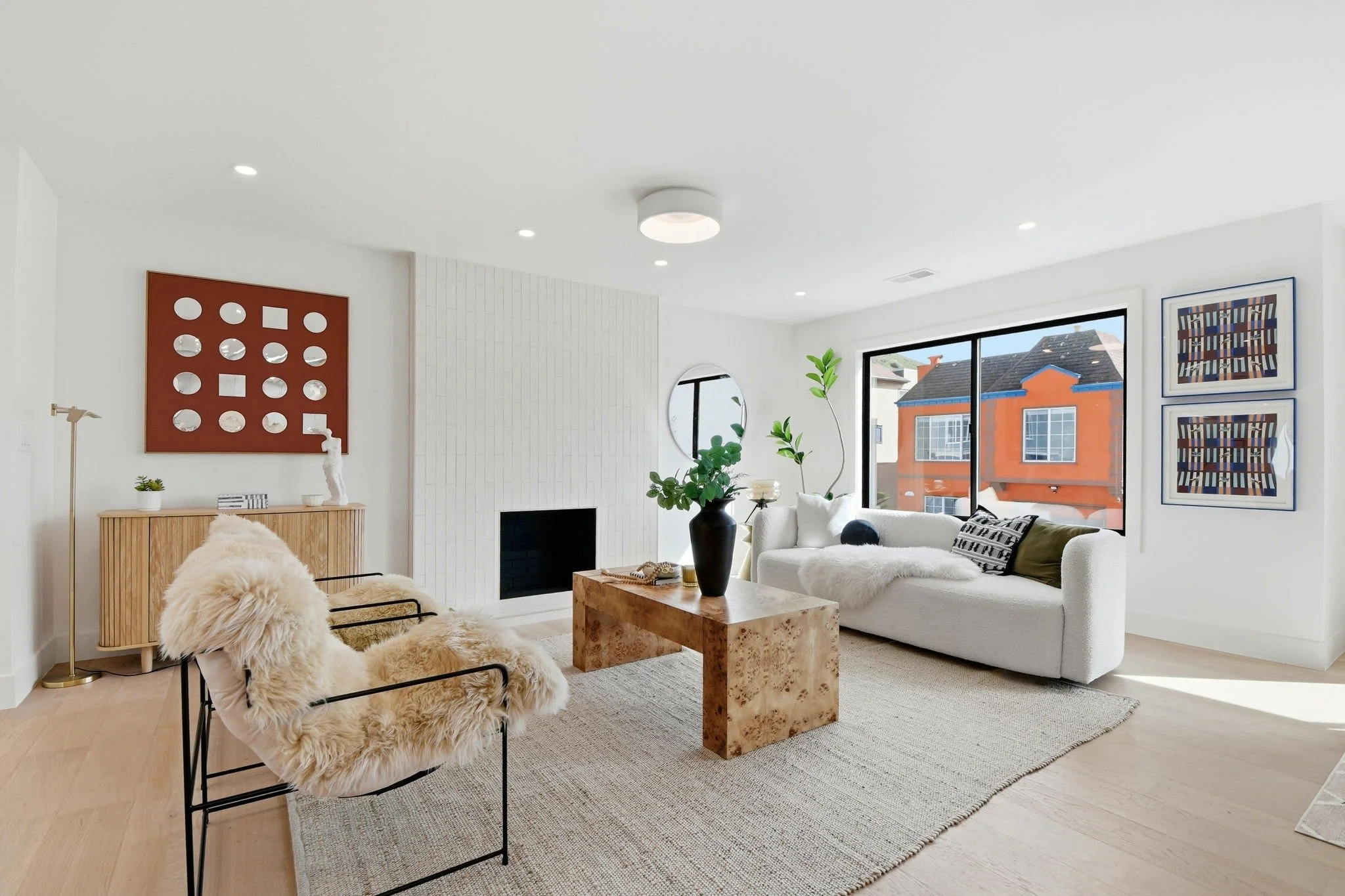 Sophisticated living space featuring a minimalist white vertical-tile fireplace and a burled wood coffee table in a luxury San Francisco home.