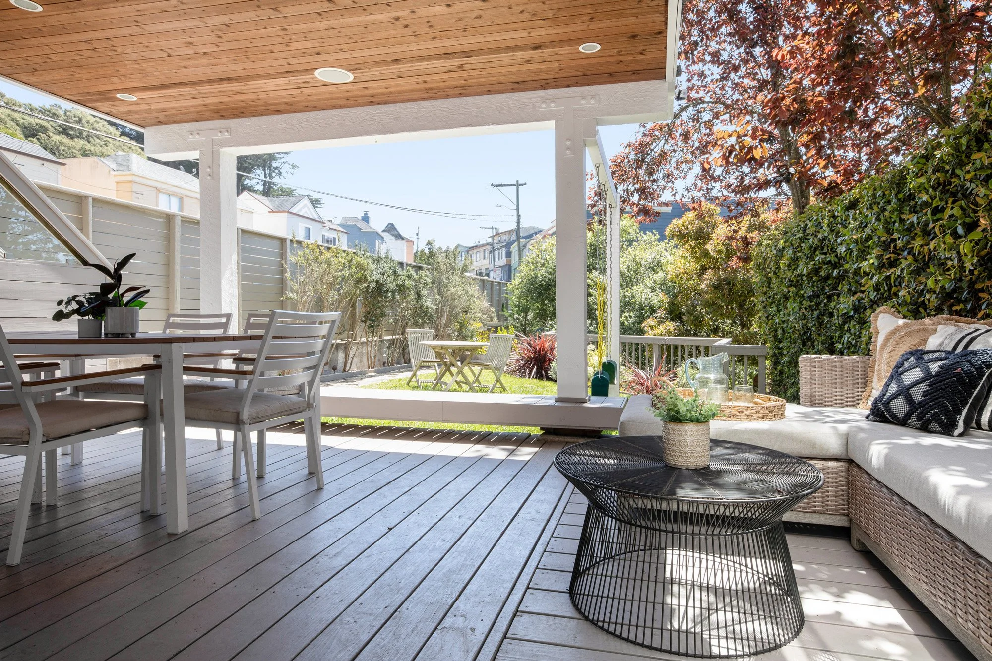Expansive covered outdoor deck with a dining area and lounge seating, perfect for hosting and entertaining.