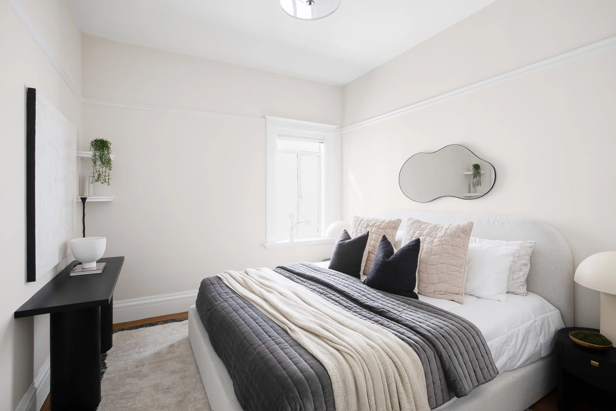 Bedroom at 465 30th Street with period picture rail molding, tall baseboards, original window trim and hardwood floors