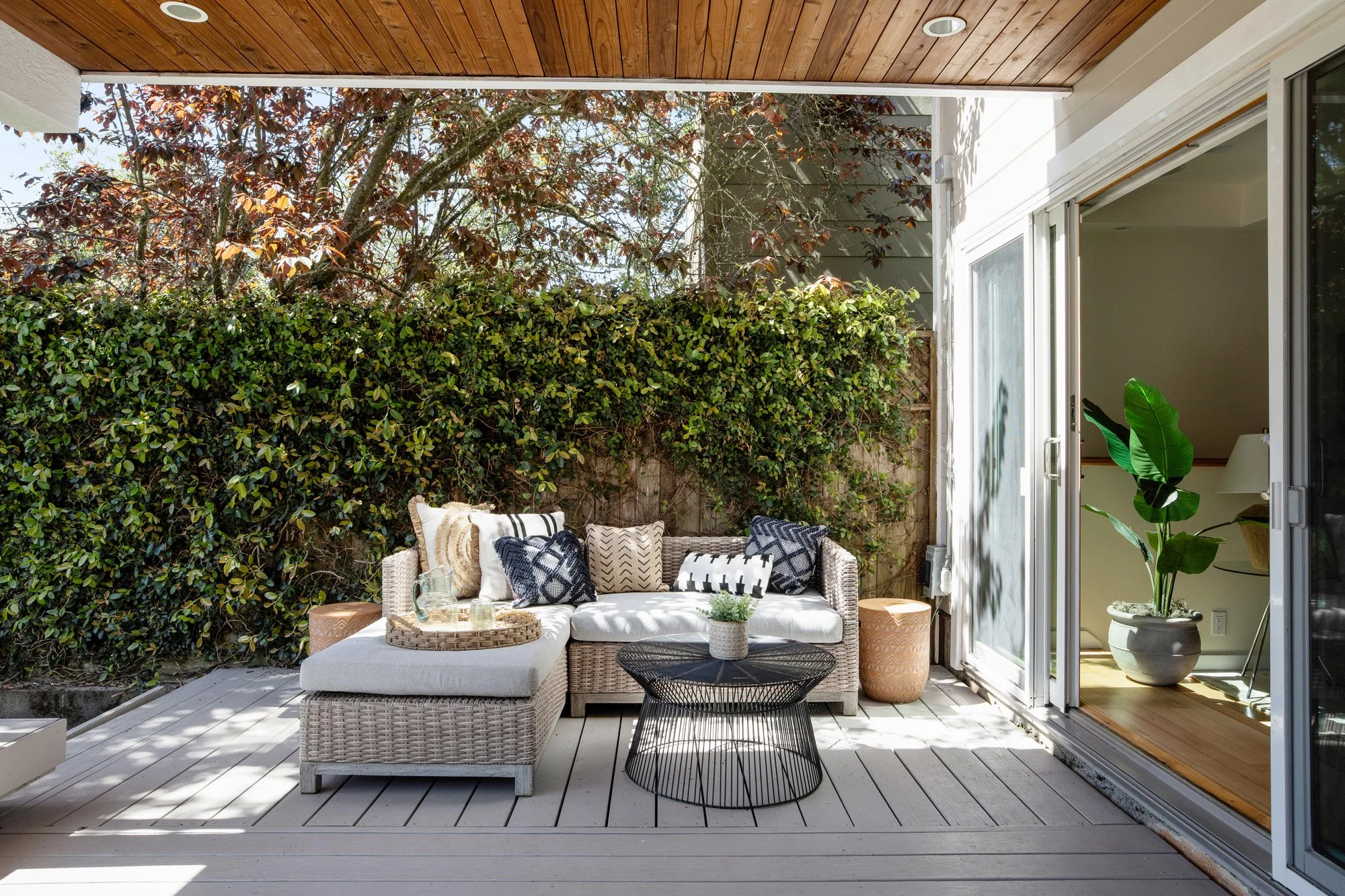 Bright, covered outdoor terrace with sliding glass door access to the main living room, perfect for indoor-outdoor entertaining.