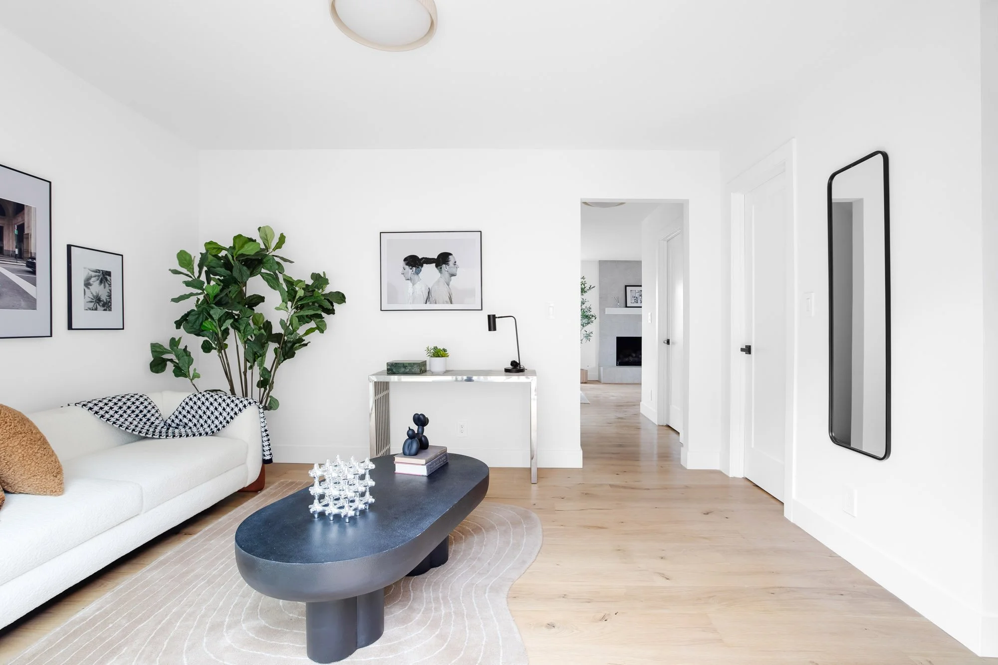 Ground-floor bonus room at 75 Aloha Avenue, San Francisco, looking through to the living room and its tiled gas fireplace.