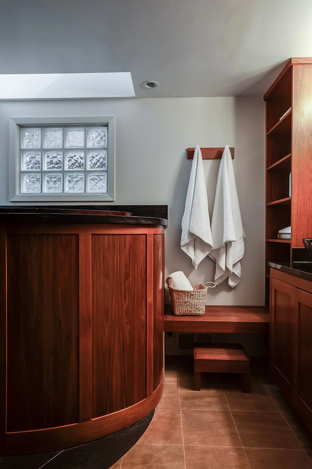 Close-up of custom wood architectural detailing and storage in a renovated luxury bathroom, highlighting the premium craftsmanship of this San Francisco residence.