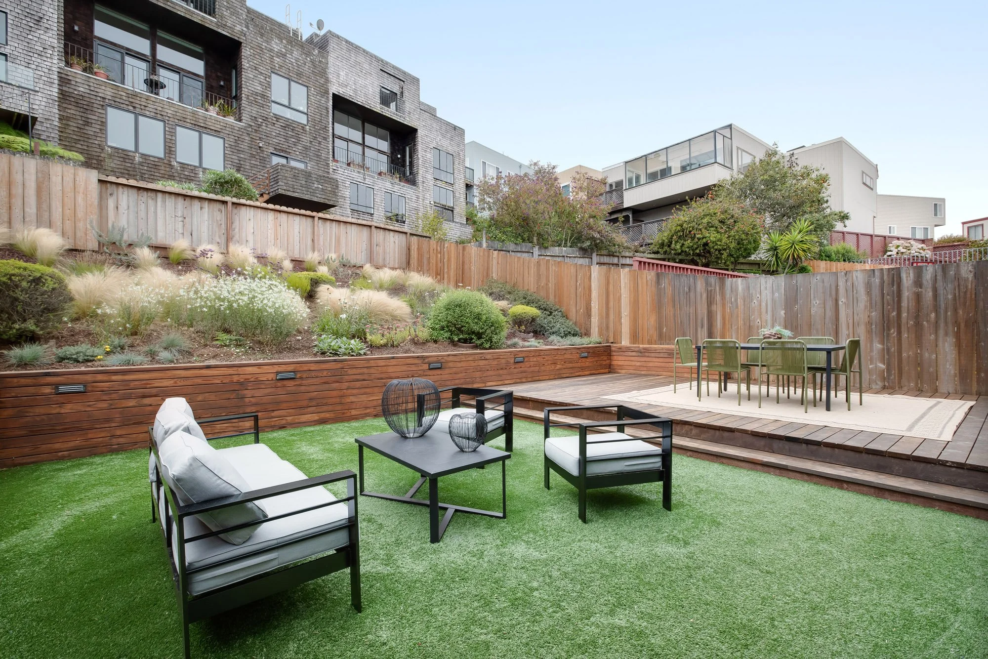 Turfed lawn and refinished deck at 75 Aloha Avenue in Golden Gate Heights, San Francisco, below a hillside planted in drought-tolerant Mediterranean species.