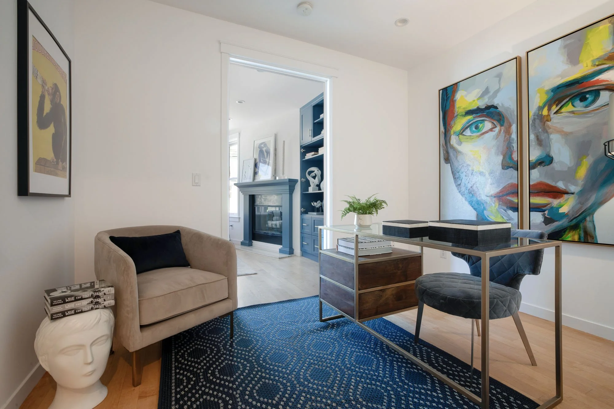 Luxury dining room design with a minimalist wood table, white upholstered chairs, and large-scale black and white abstract wall art near a balcony.