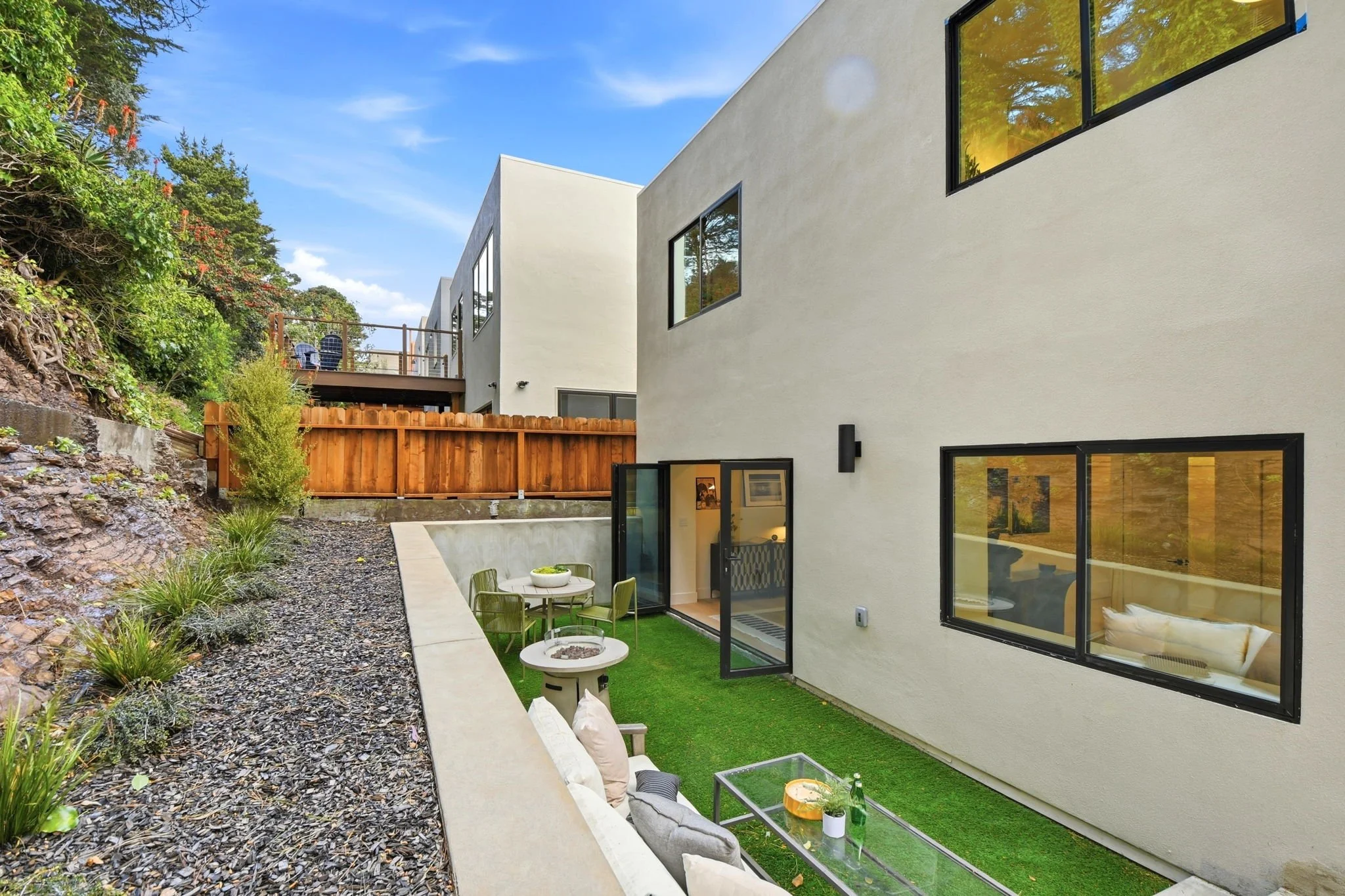 Elevated view of a secluded urban backyard and modern exterior facade at a luxury Midtown Terrace residence, highlighting the seamless indoor-outdoor transition.