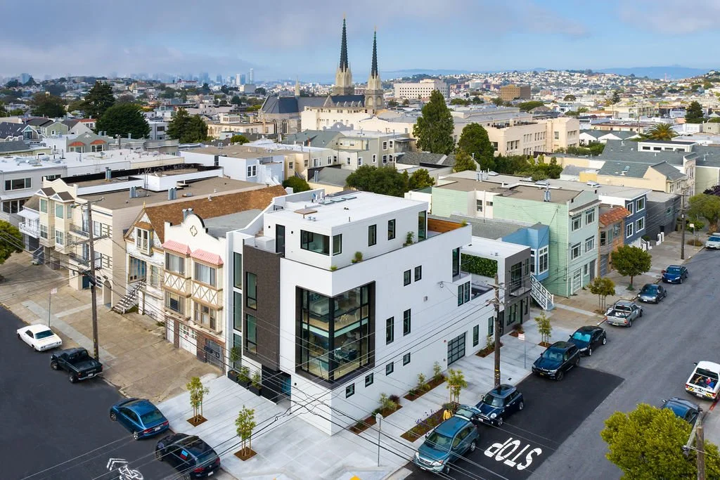 Aerial drone view of 1647 Sanchez, a $12M modern architectural masterpiece in San Francisco’s Noe Valley, featuring multi-level rooftop terraces, floor-to-ceiling glass, and panoramic views of the city skyline.