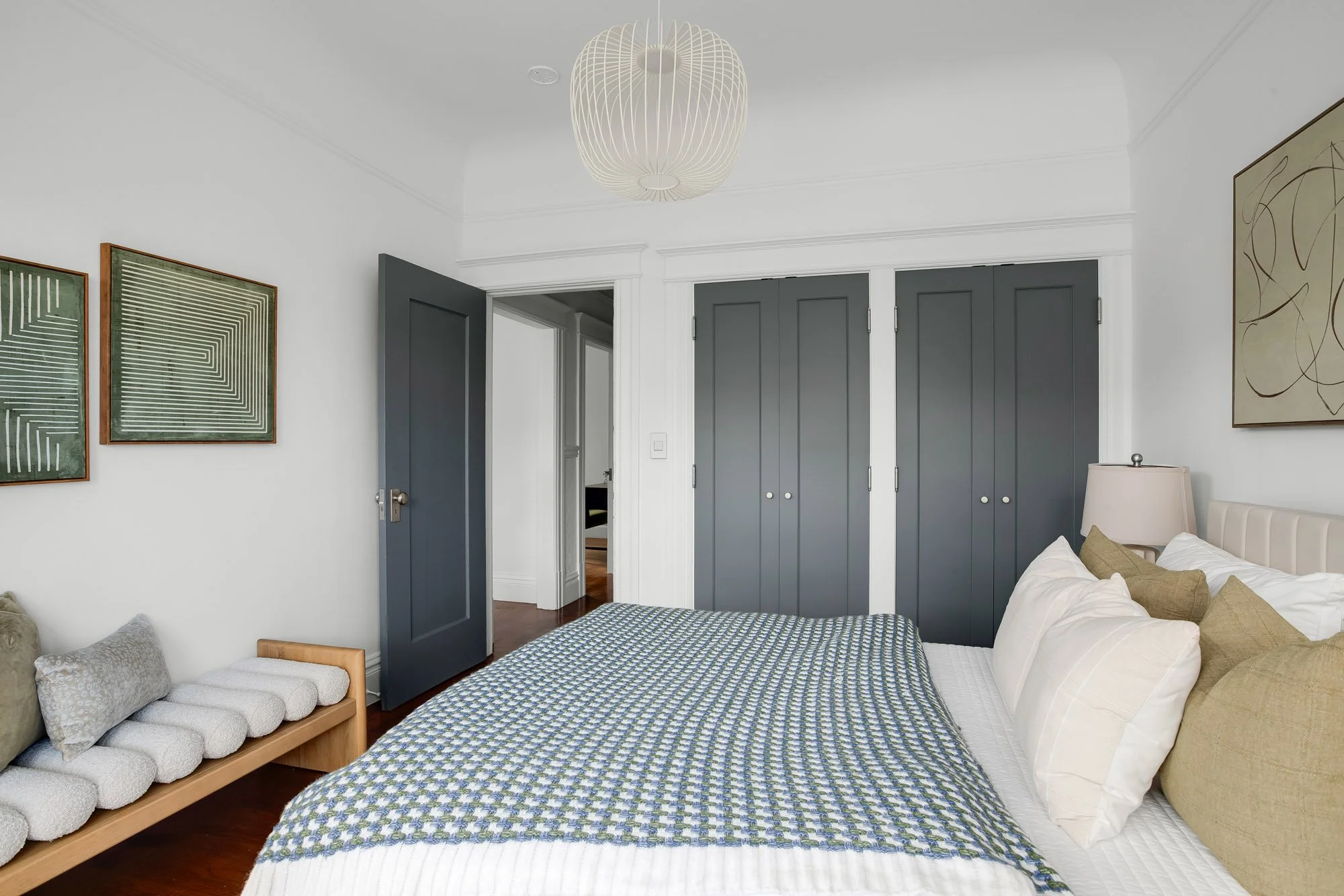 econd bedroom with large dual closet, original Victorian crown molding, hardwood floors, and direct access to hallway in luxury Presidio Heights Victorian flat on Sacramento Street, San Francisco