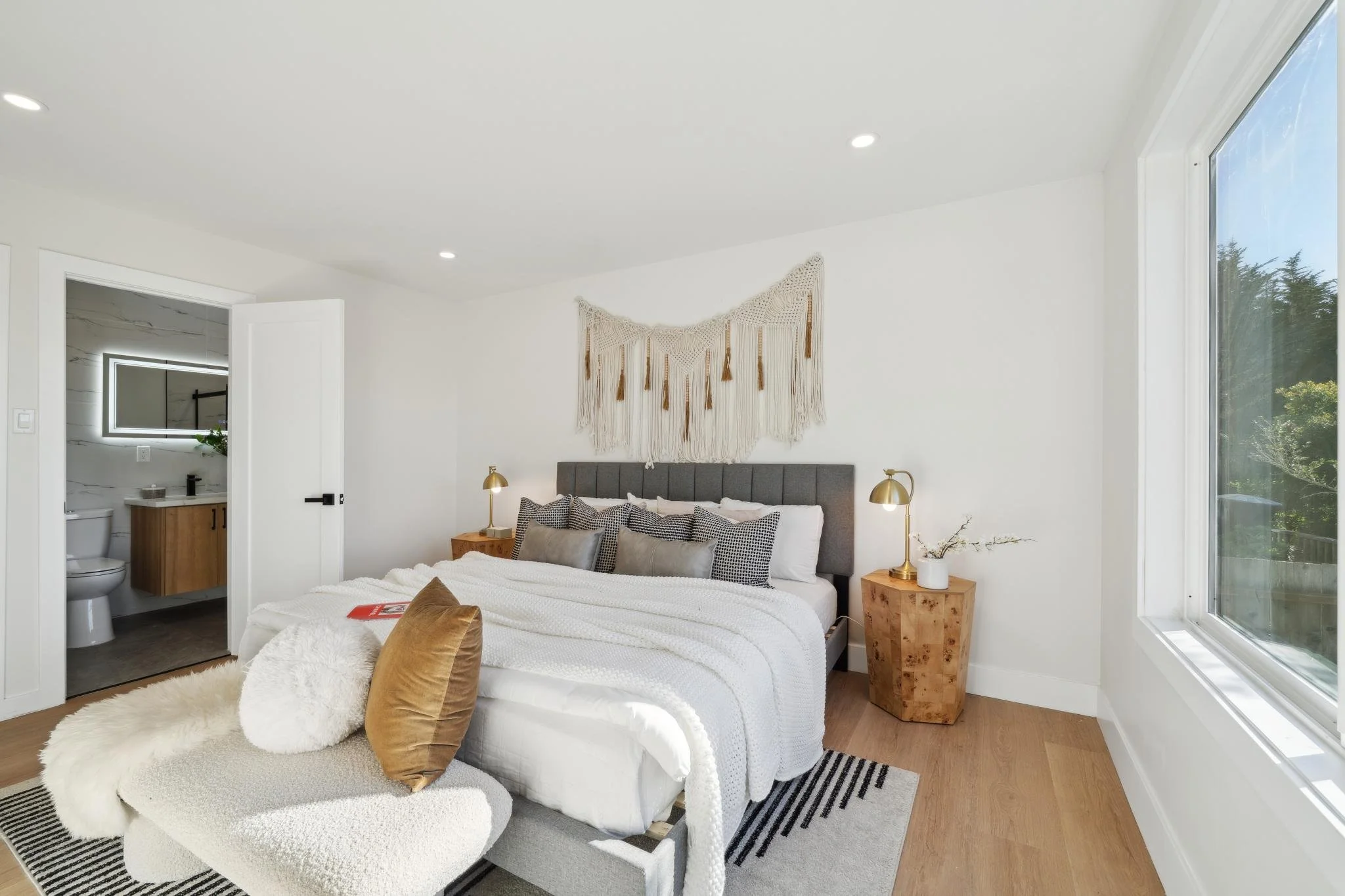Wide view of the primary suite at 147 Gladeview Way, showing the transition from the sleeping area to the renovated en-suite bathroom.