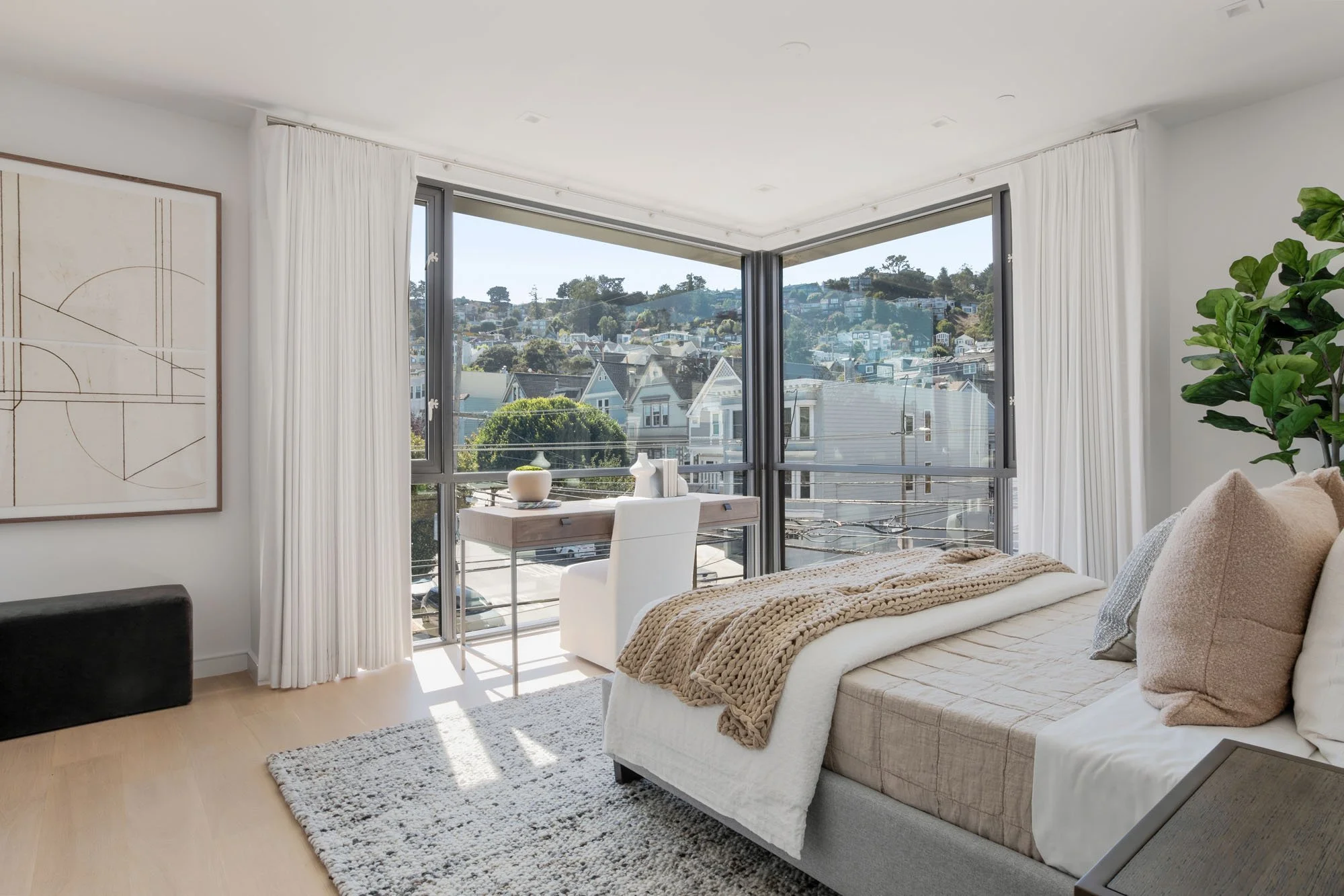 Large bedroom at 1647 Sanchez boasting floor-to-ceiling corner windows with panoramic views of San Francisco hills and Victorian architecture.