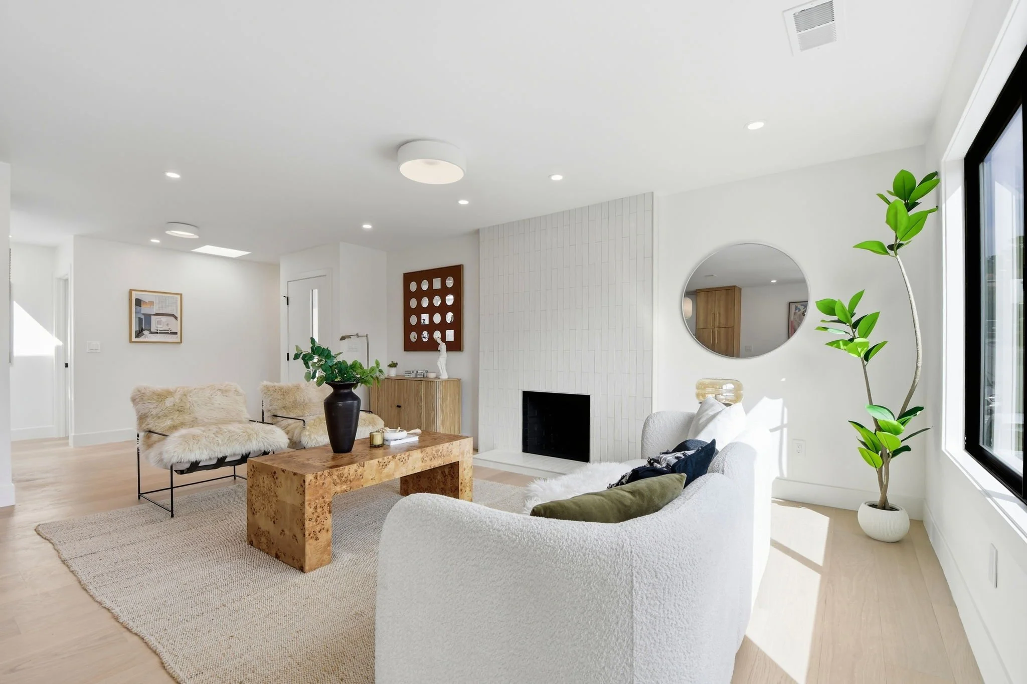 Light-filled living room highlighting a seamless floor plan and high-end staging in a premium Midtown Terrace real estate listing.