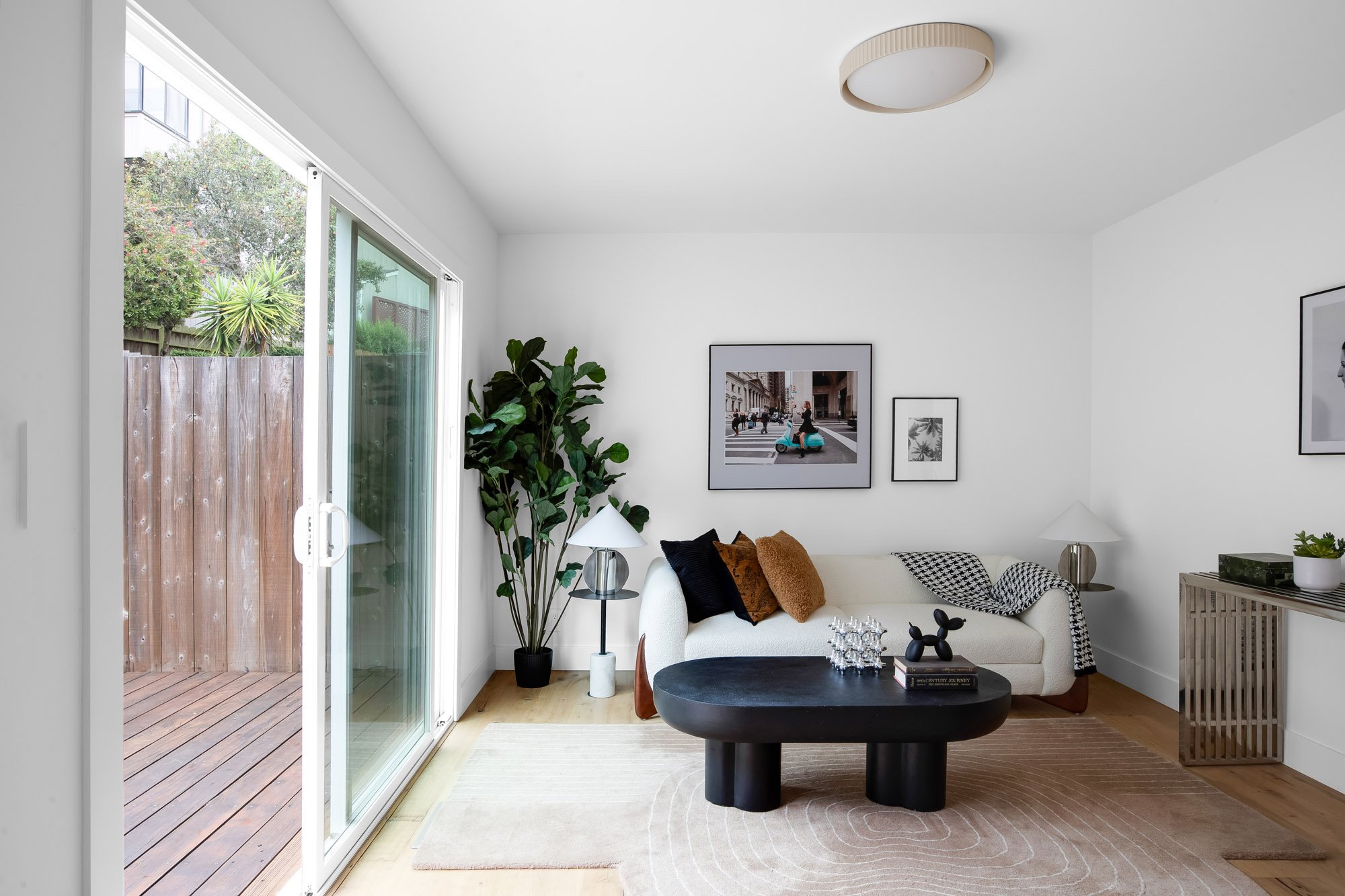 Ground-floor bonus room at 75 Aloha Avenue in Golden Gate Heights, San Francisco, with a sliding glass door open to the refinished rear deck.