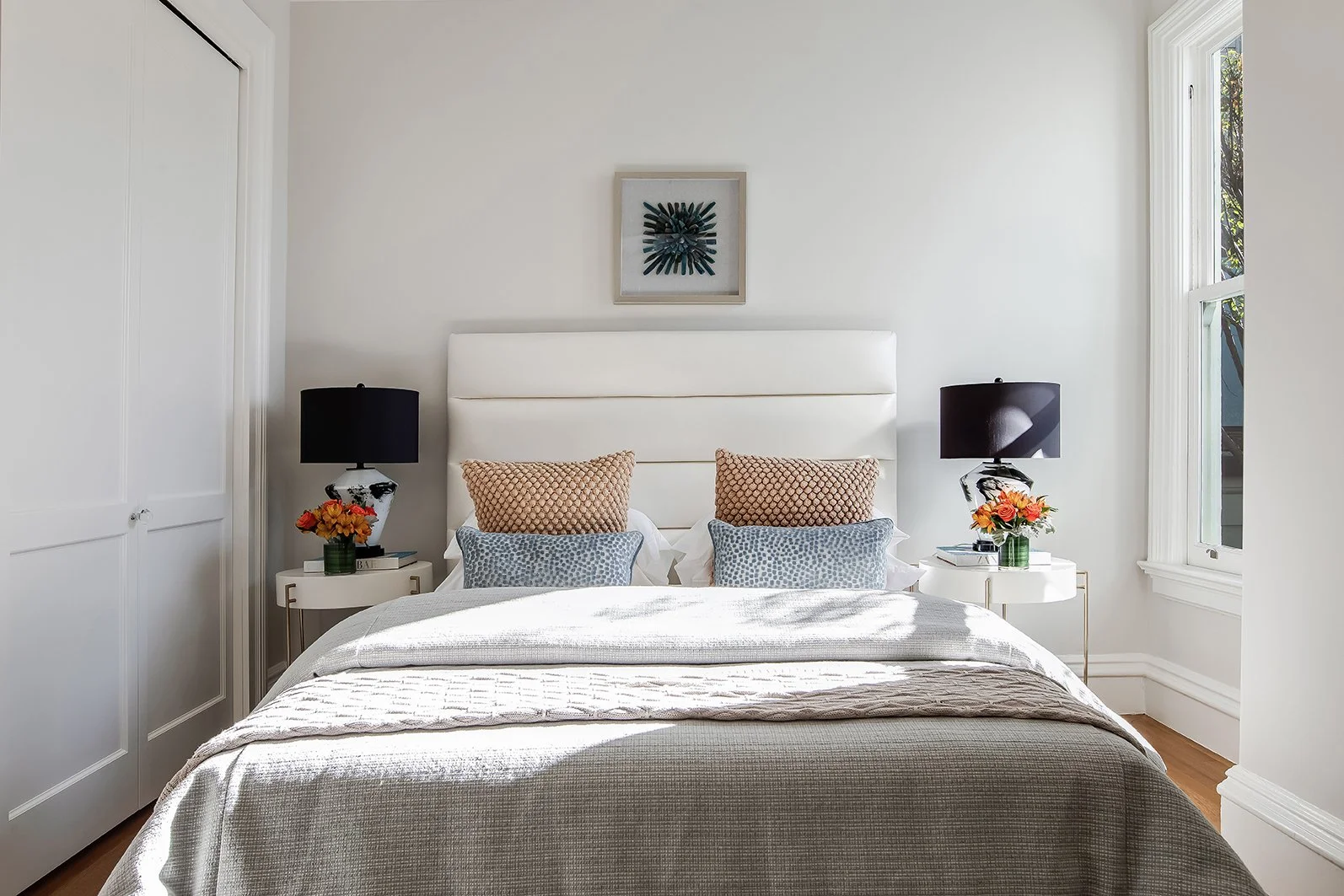 Sophisticated master bedroom suite with an upholstered headboard, designer lighting, and neutral decor in a luxury Victorian property.