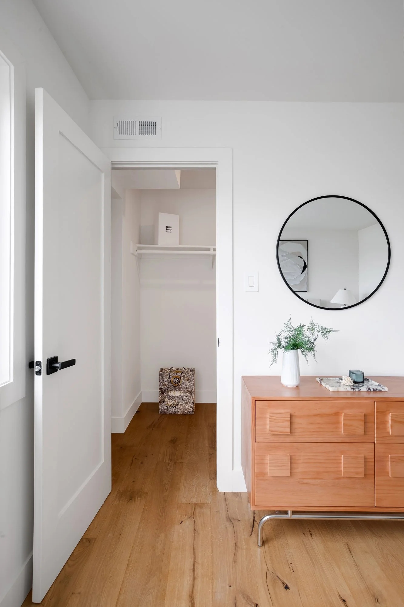 Walk-in closet off the primary bedroom at 75 Aloha Avenue in Golden Gate Heights, with hanging rod, shelf, and oak flooring.