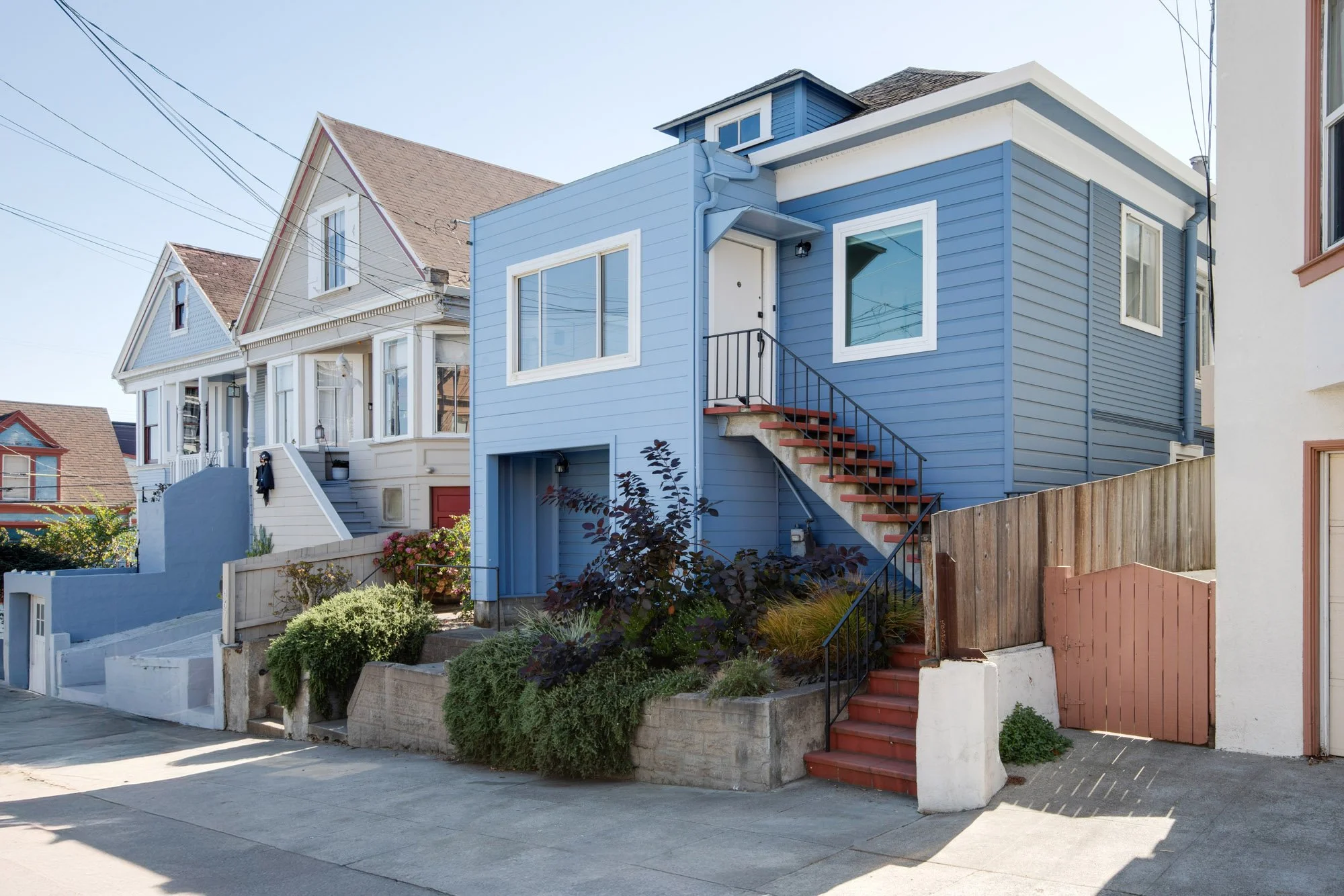 Exterior of 465 30th Street, a detached single-family home in Upper Noe Valley, San Francisco, with blue siding, new windows and drought-tolerant front landscaping