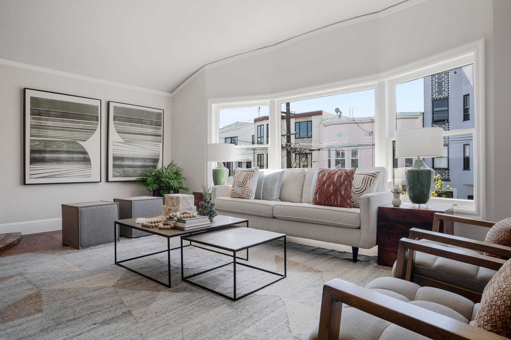 Bright, sun-filled living room at 2872 25th Street with a large bay window, contemporary furniture, and neutral interior design.