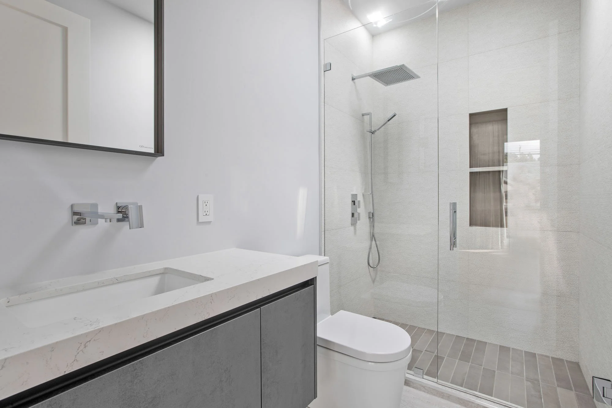 Contemporary guest bathroom at 1647 Sanchez with a frameless glass walk-in shower, floating vanity, and sleek monochromatic tile work.