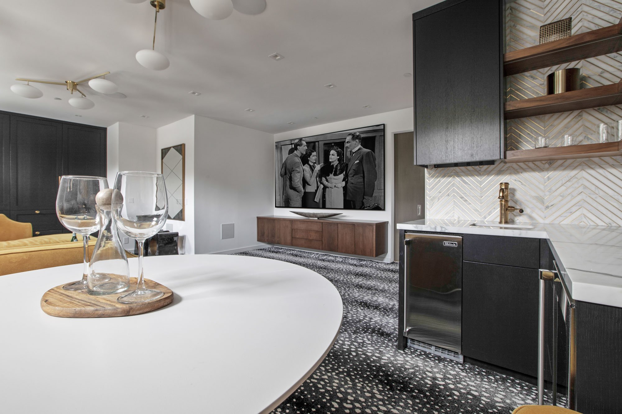 High-end entertainment room at 1647 Sanchez featuring a custom wet bar, wine refrigeration, and a large-format media area.