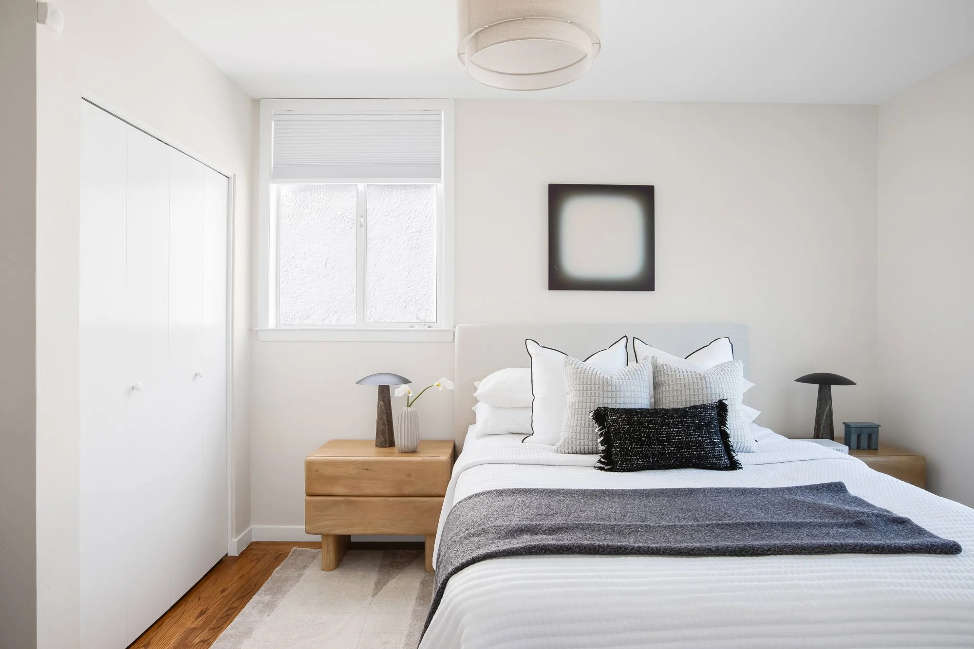 Bedroom in an Upper Noe Valley single-family home with a double closet, hardwood floors and a window