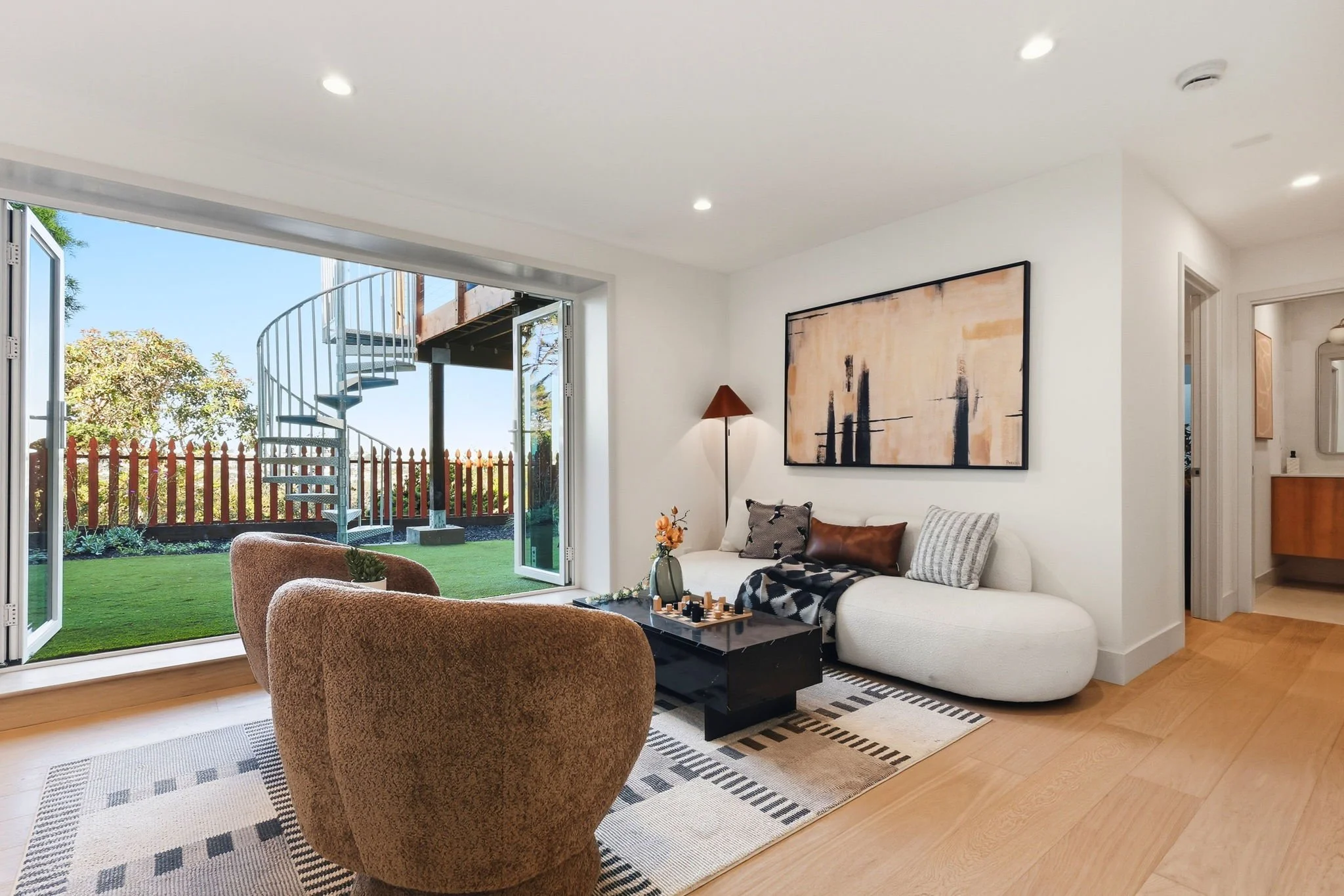 Downstairs Den with open rear doors and stairs to upper deck 75 Knollview Way