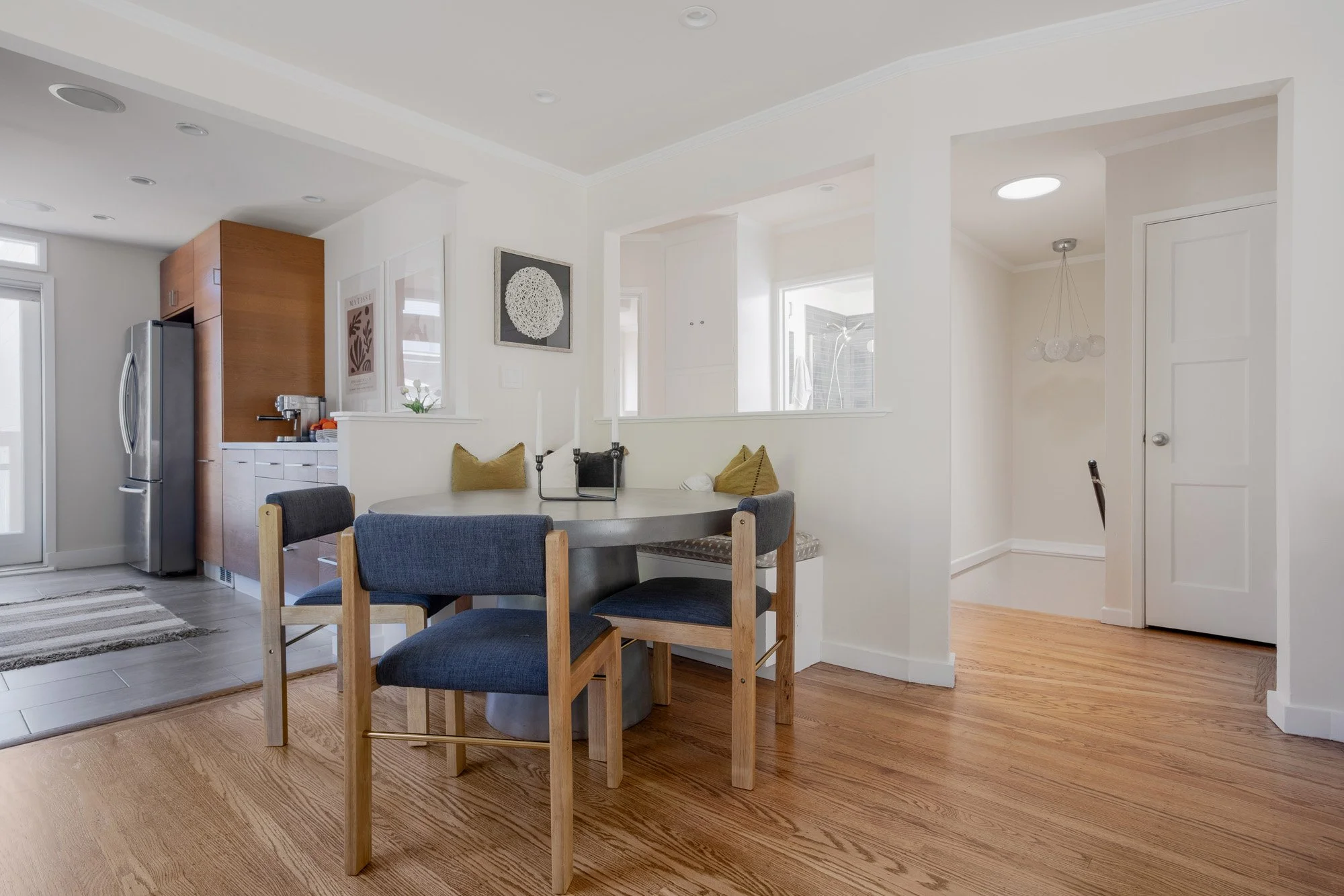 Light-filled open floor plan showing the seamless flow between the kitchen, dining room, and staircase.